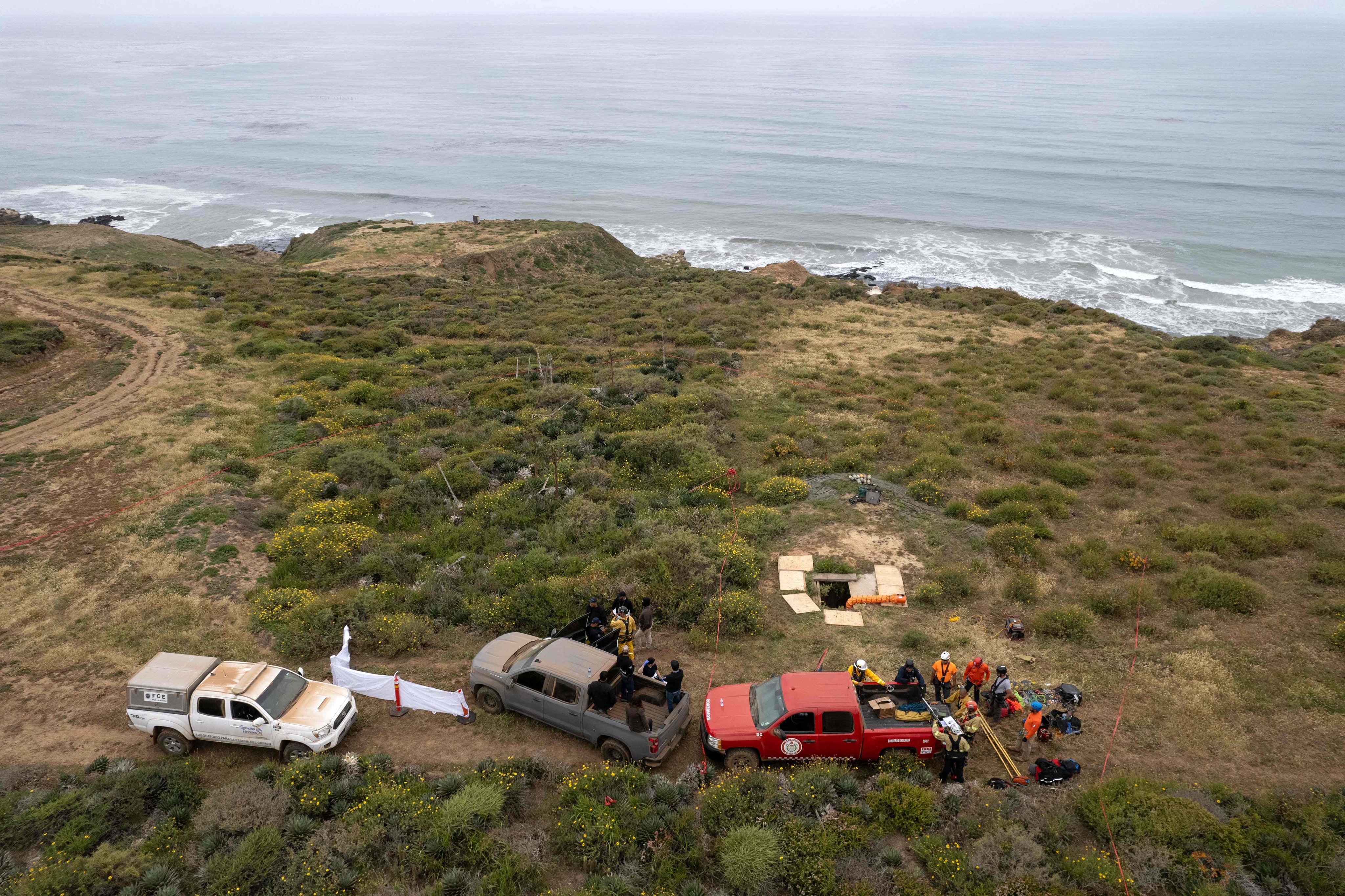 Rescuers, forensics officers and prosecutors prepare to enter a waterhole where the surfers’ bodies were found on May 3, 2024. Photo: AFP
