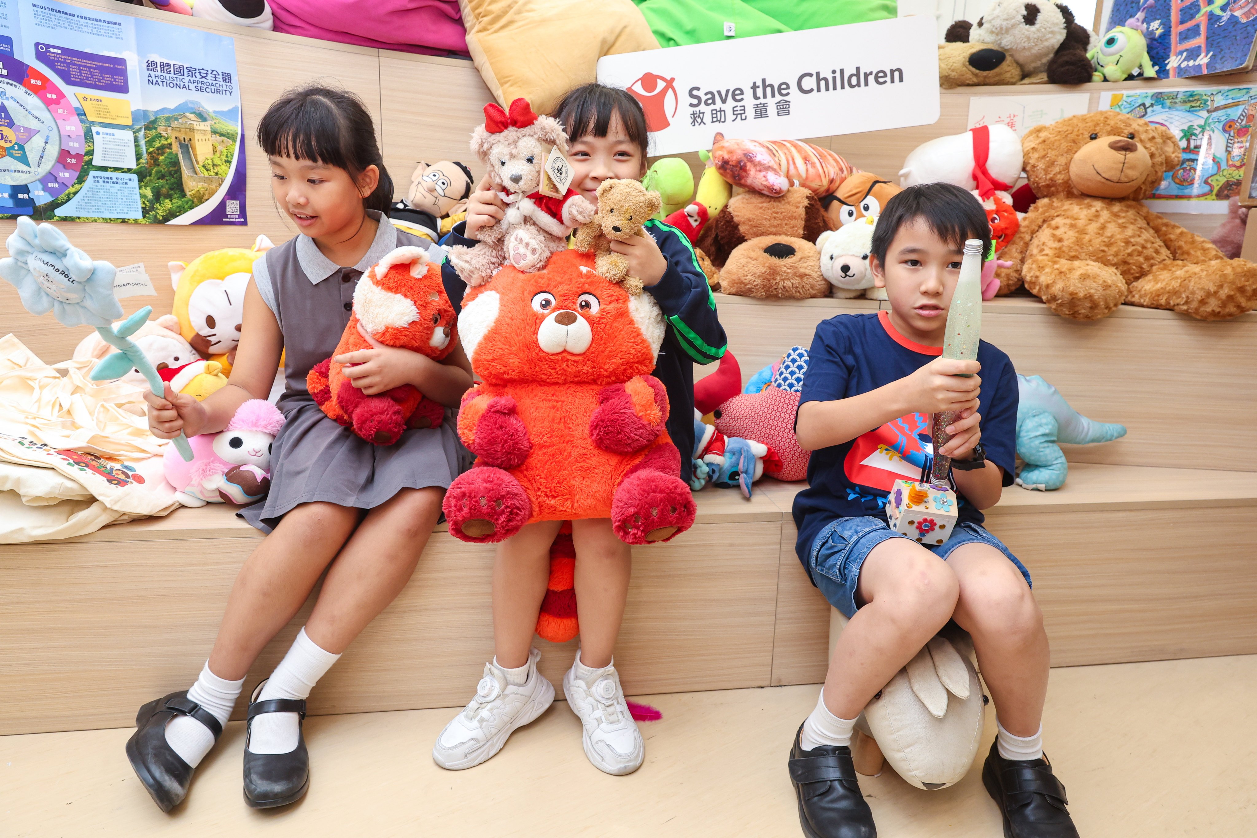 (From left) Sze Yu, Hei Ting and Jackey are part of a therapy programme by Save the Children Hong Kong to help young survivors of the Tai Po fire. Photo: Edmond So