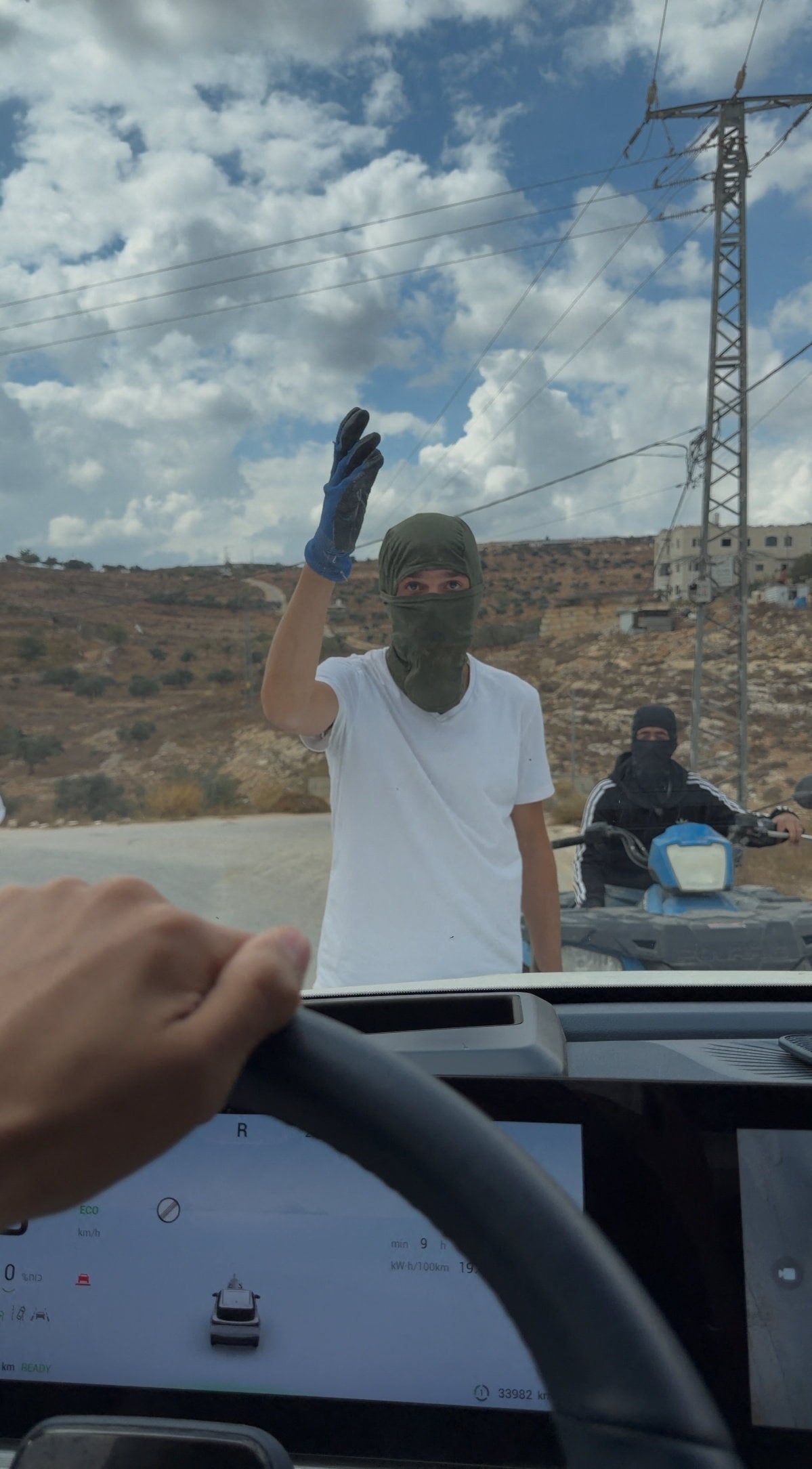 Masked people are seen at the site of an alleged attack on Western diplomats and officials in Taybeh on Saturday. Photo: Amit Orfali via Reuters