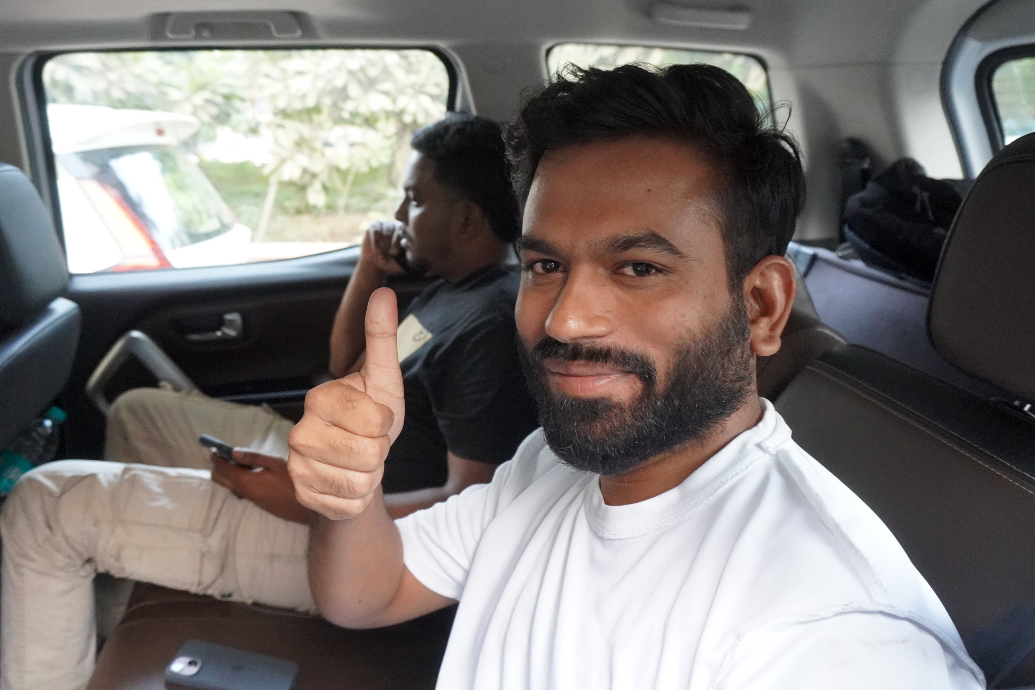 Abhijeet Dipke, founder of the Cockroach Janta Party, gestures from inside a vehicle after he was released on bail in New Delhi on Saturday. Photo: AP