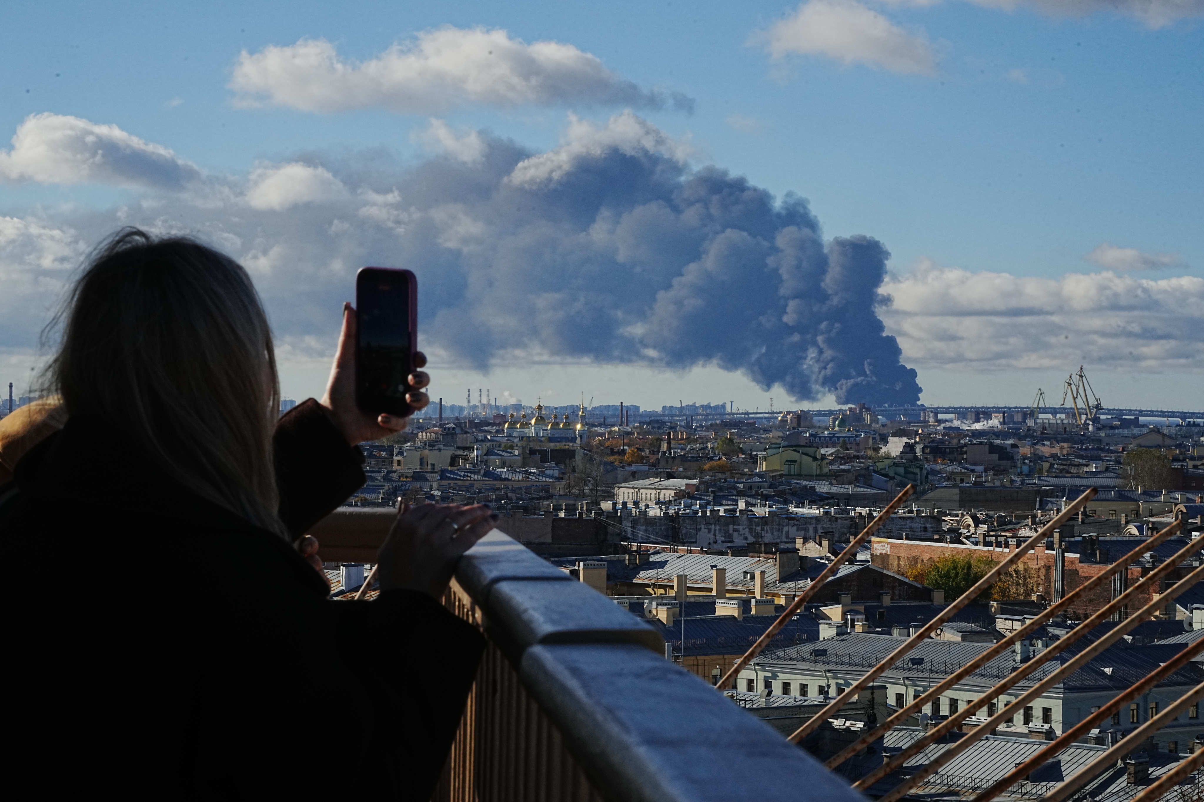 Smoke billows into the sky following Ukrainian drone strikes on an industrial zone in St Petersburg, Russia, on Sunday, Photo: UGC via AP