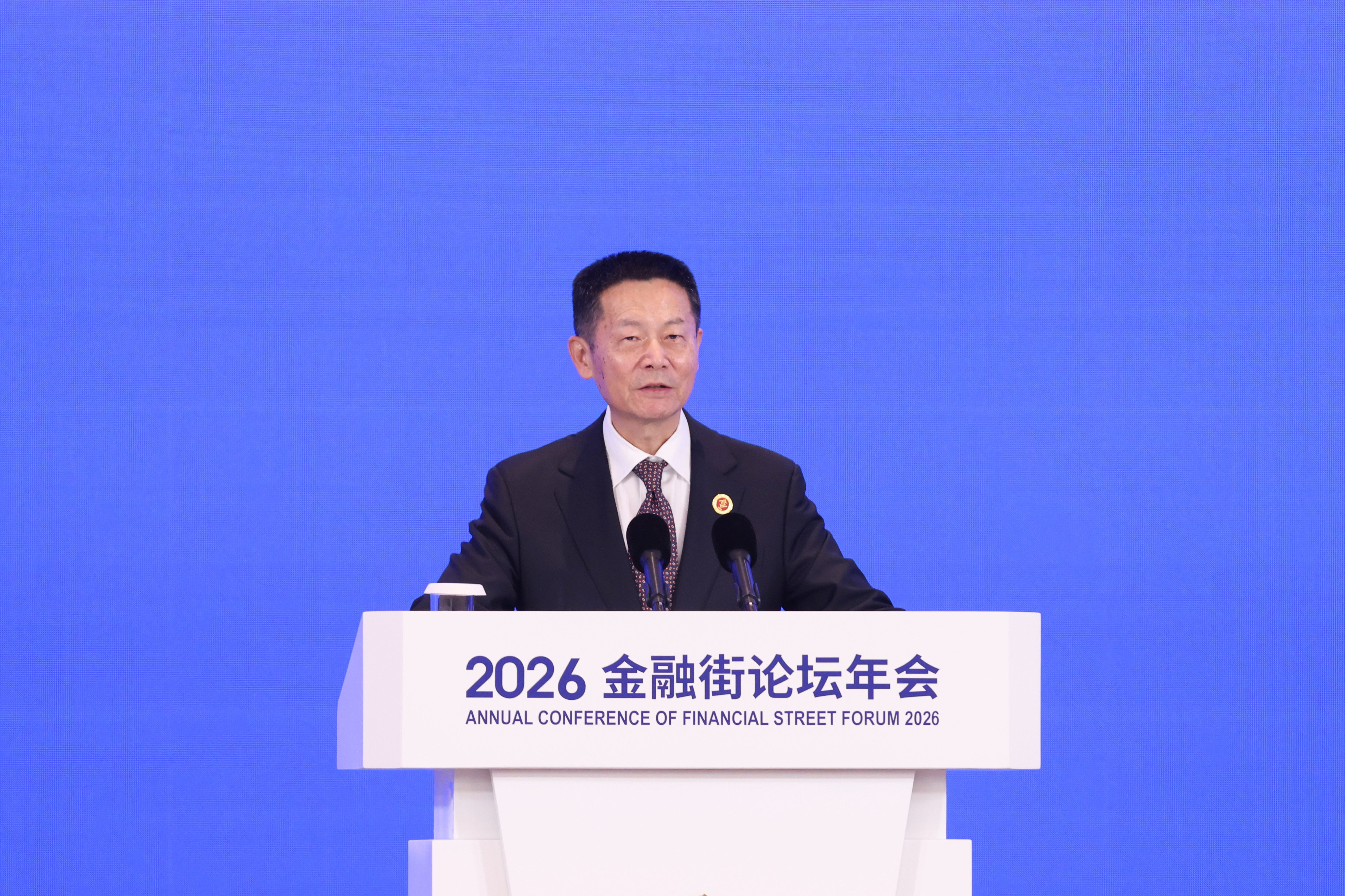 Wu Qing, chairman of the China Securities Regulatory Commission, speaks at the opening of the 2026 Financial Street Forum on Monday. Photo: Getty Images