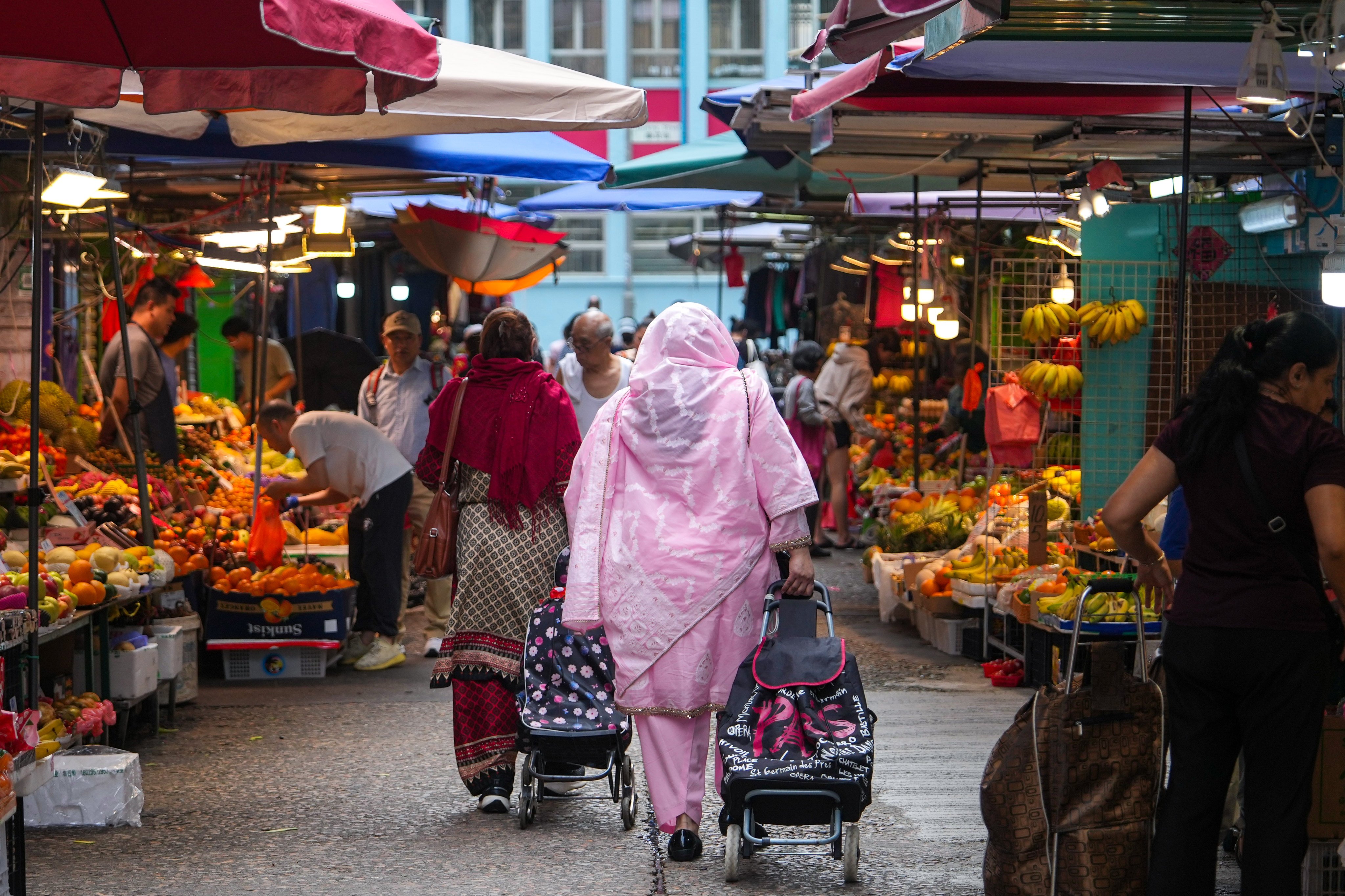 People buy fruit in Yau Ma Tei on March 26. Photo: Sam Tsang