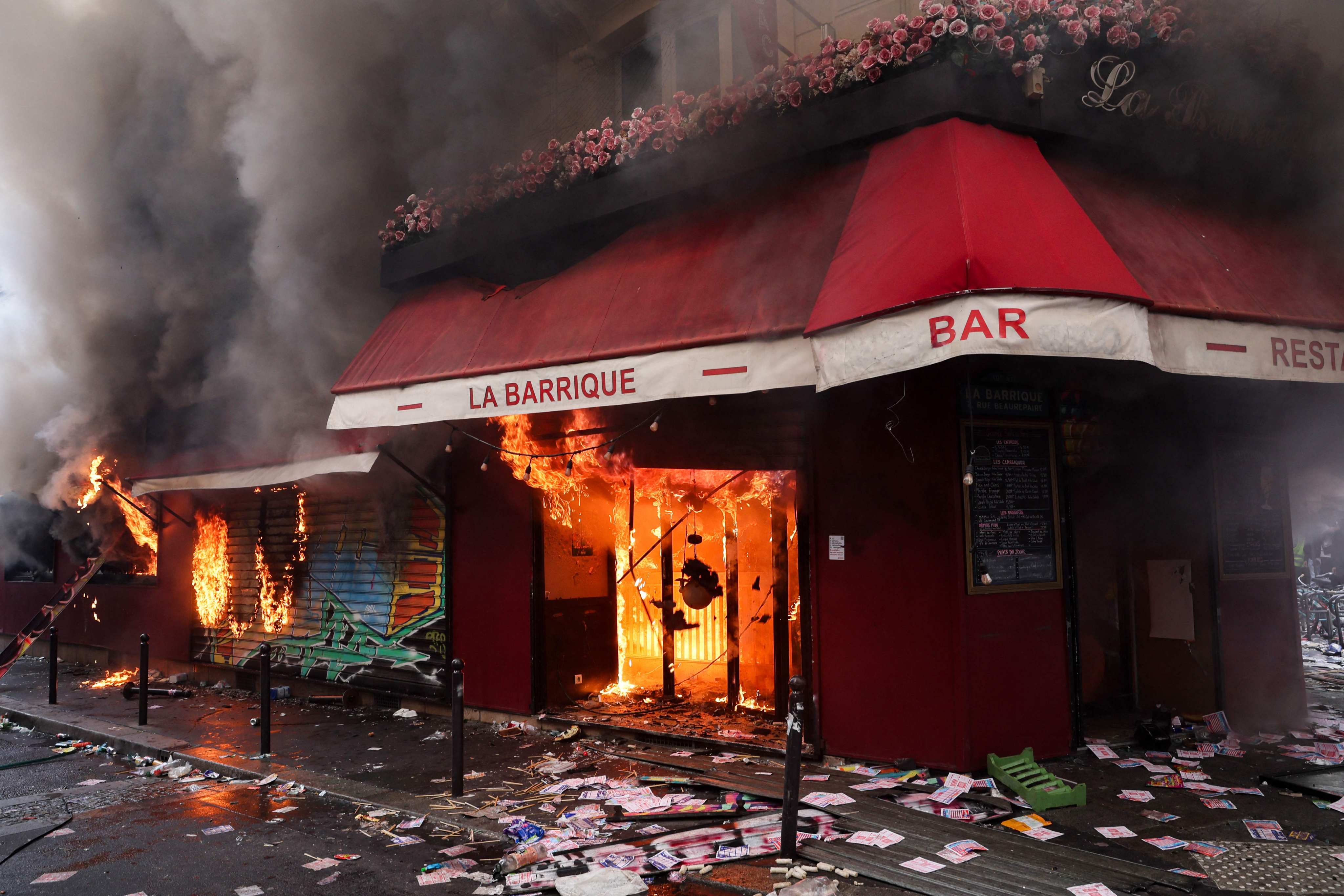Smoke rises from the bar La Barrique, owned by Chinese immigrant Aline Li, on the sidelines of a demonstration in Paris on October 17. Photo: AFP