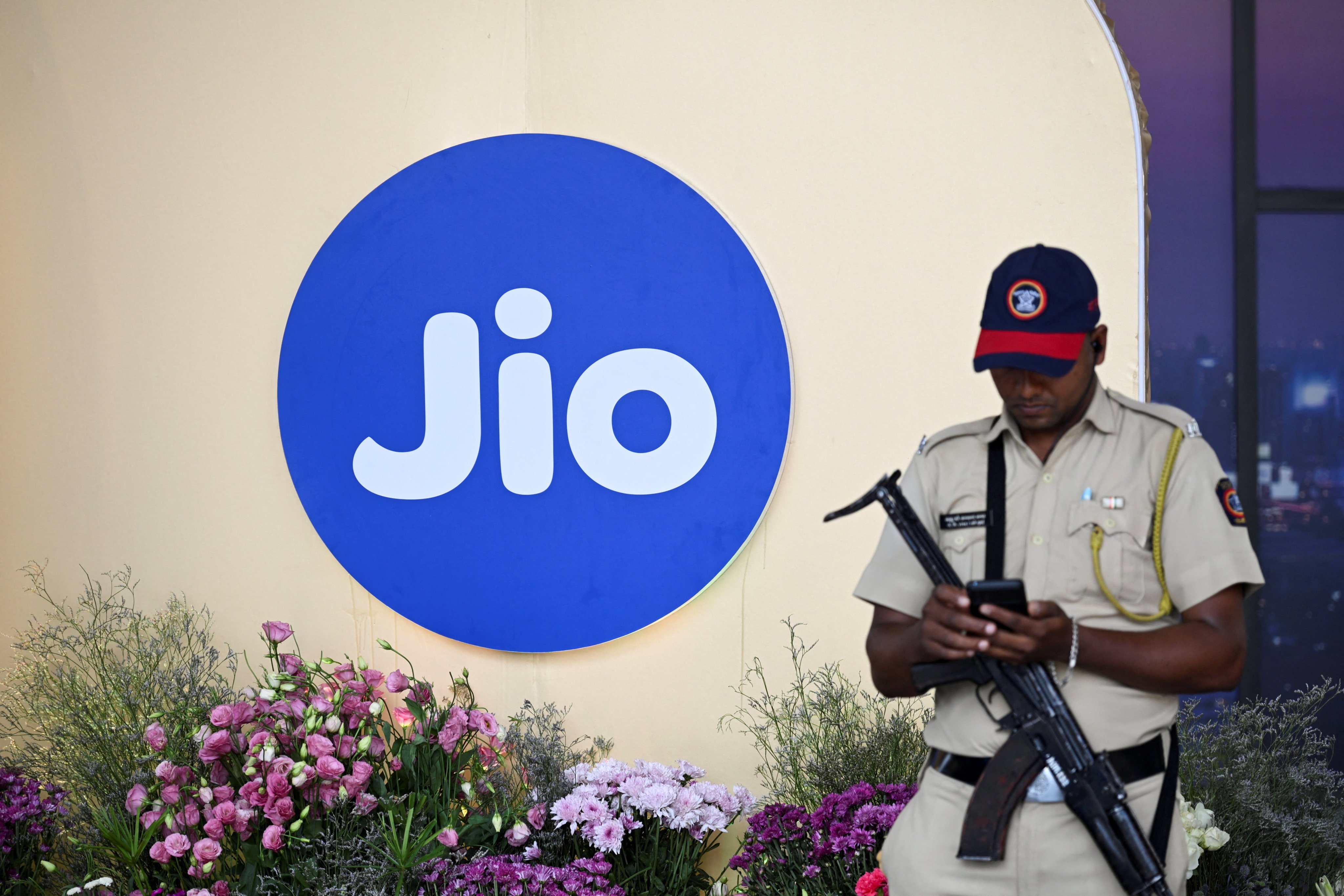 A security officer is pictured beside the Jio logo during a news conference for the Jio Platforms IPO in Mumbai, India, on Thursday. Jio Platforms is aiming for a US$108 billion valuation in India’s biggest-ever IPO. Photo: Reuters