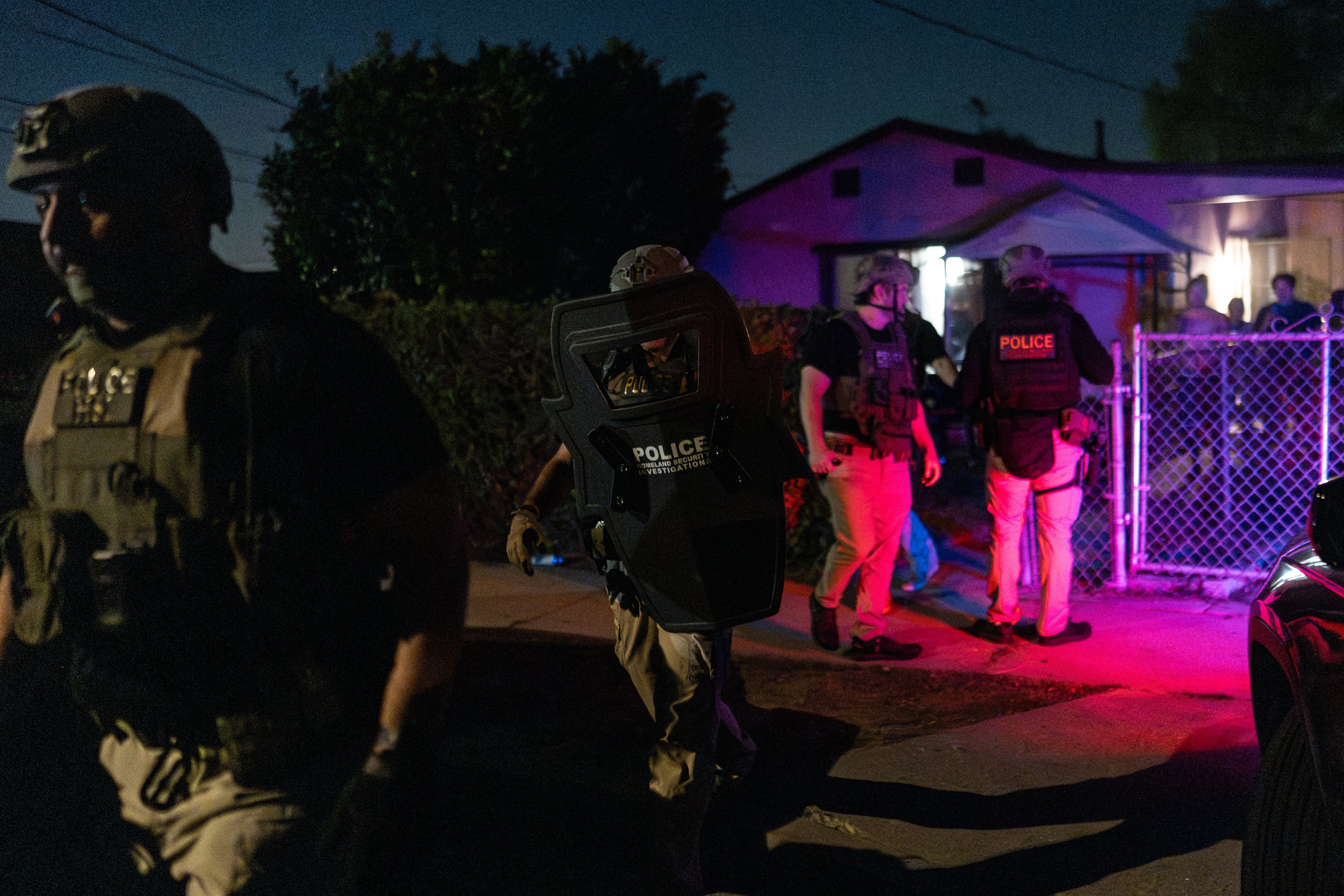 Homeland Security Investigations officers leave a home after arresting a suspect accused of illegally registering to vote during a federal operation in Commerce, California on Monday. Photo: AP