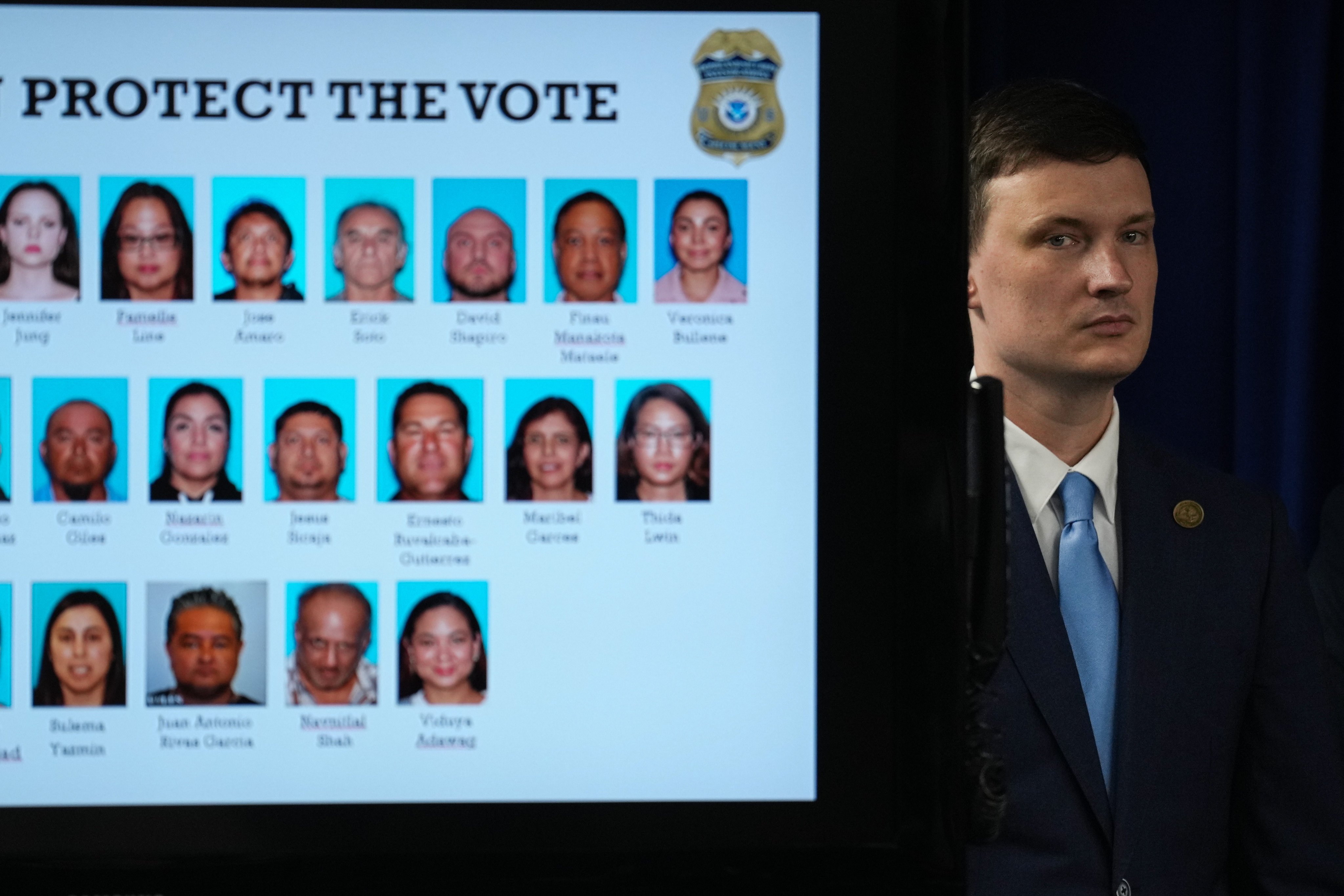 Acting US Deputy Attorney General Trent McCotter stands beside a display of people charged with illegal voter registration. Photo: AP