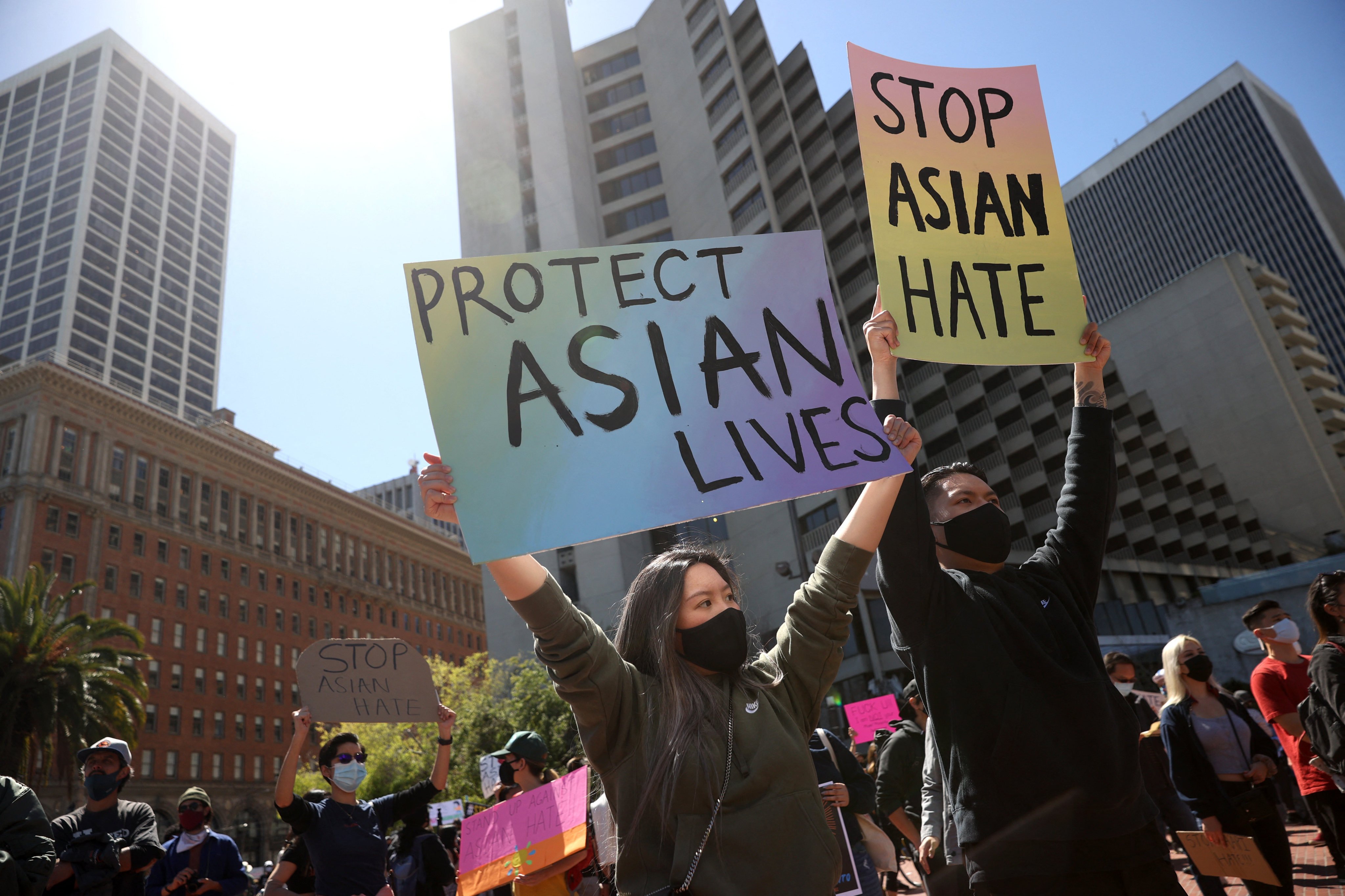 Protesters hold signs during a rally to show solidarity with Asian-Americans at Embarcadero Plaza in San Francisco, California. Photo: Getty Images via AFP