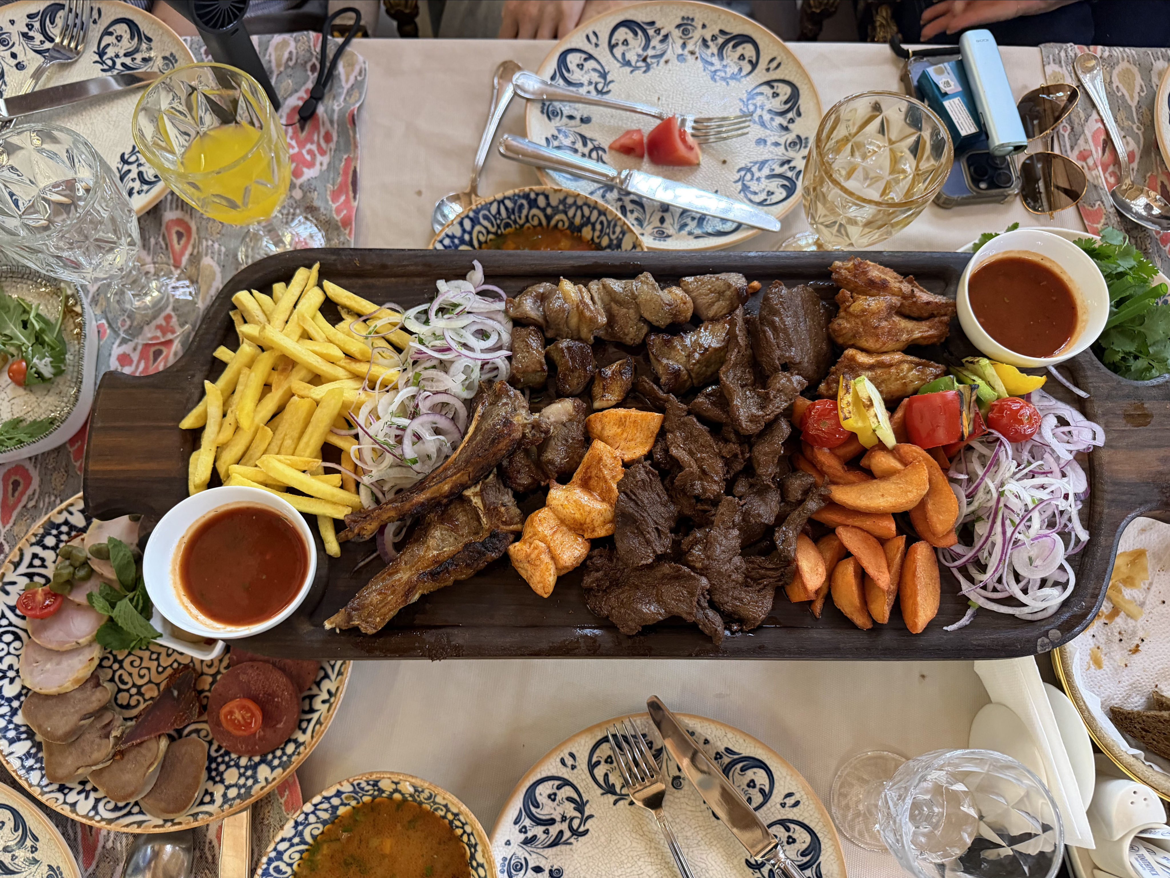 Lunch in Tashkent, featuring a spread of shashlik and cured meats. Photo: Charmaine Yu