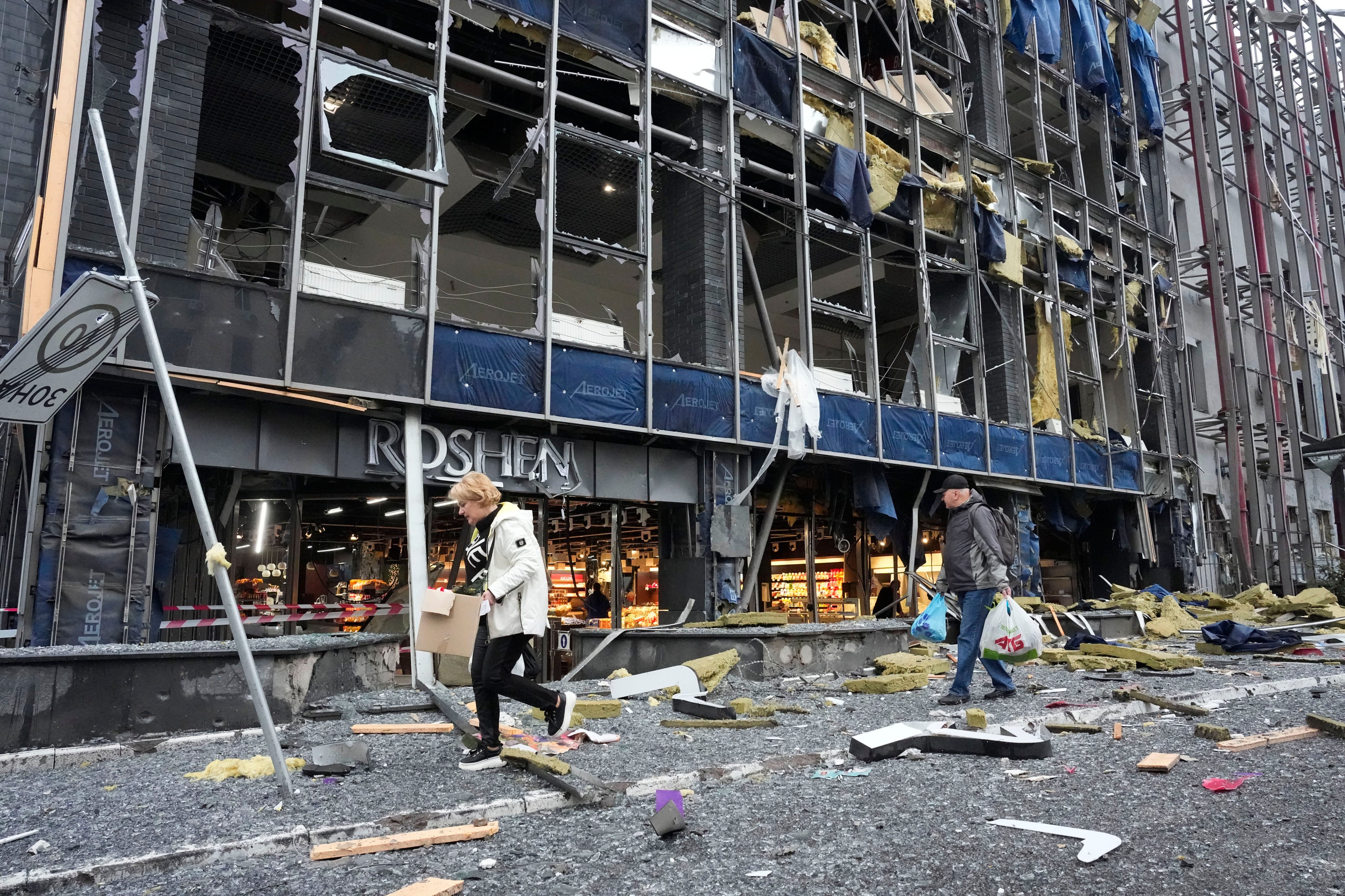 People leave their office following a Russian air attack in Kyiv on Monday. Photo: AP