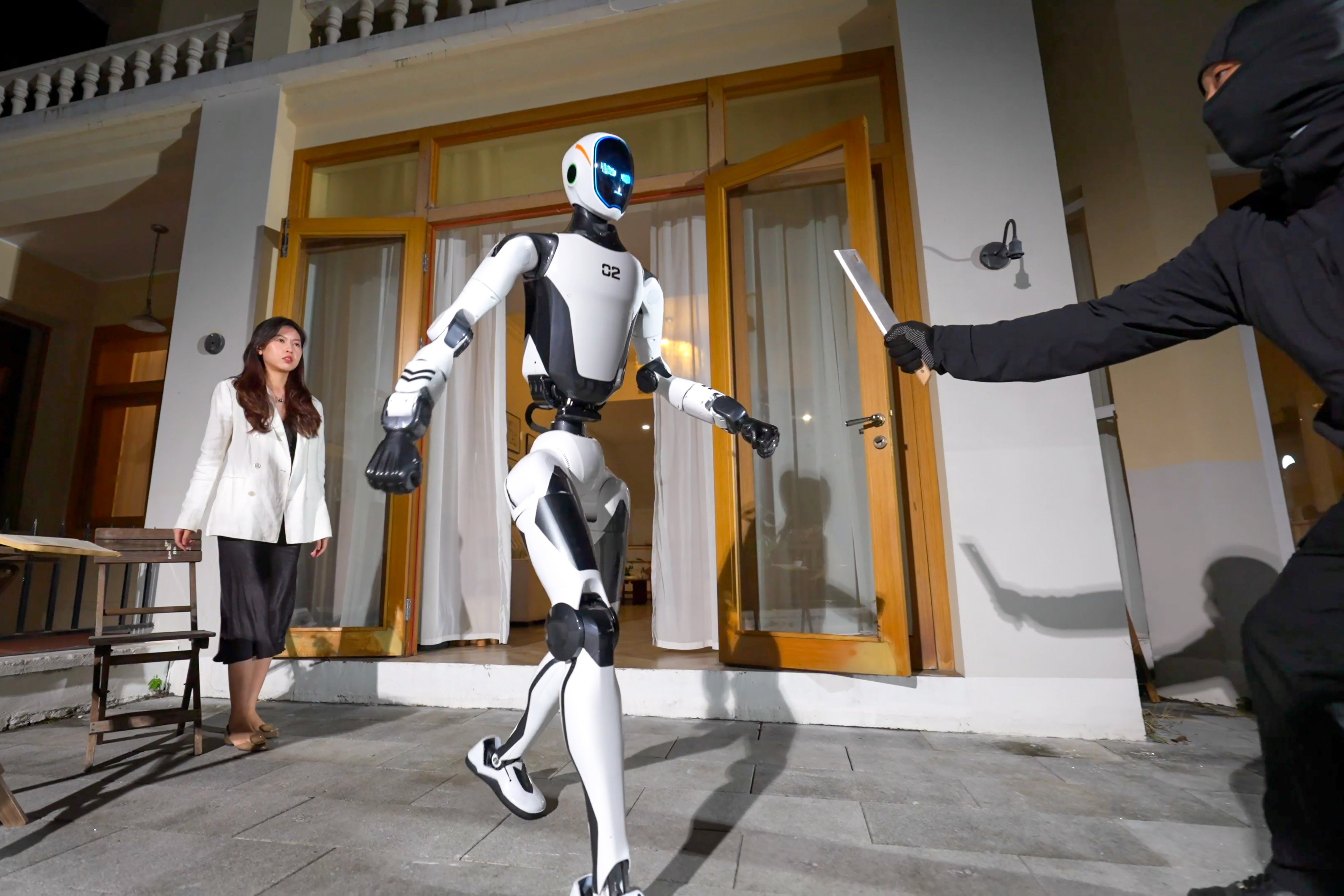 The H2-X protects a woman from a knife-wielding intruder in a promotional video released by Unitree Robotics on Wednesday. Photo: Handout