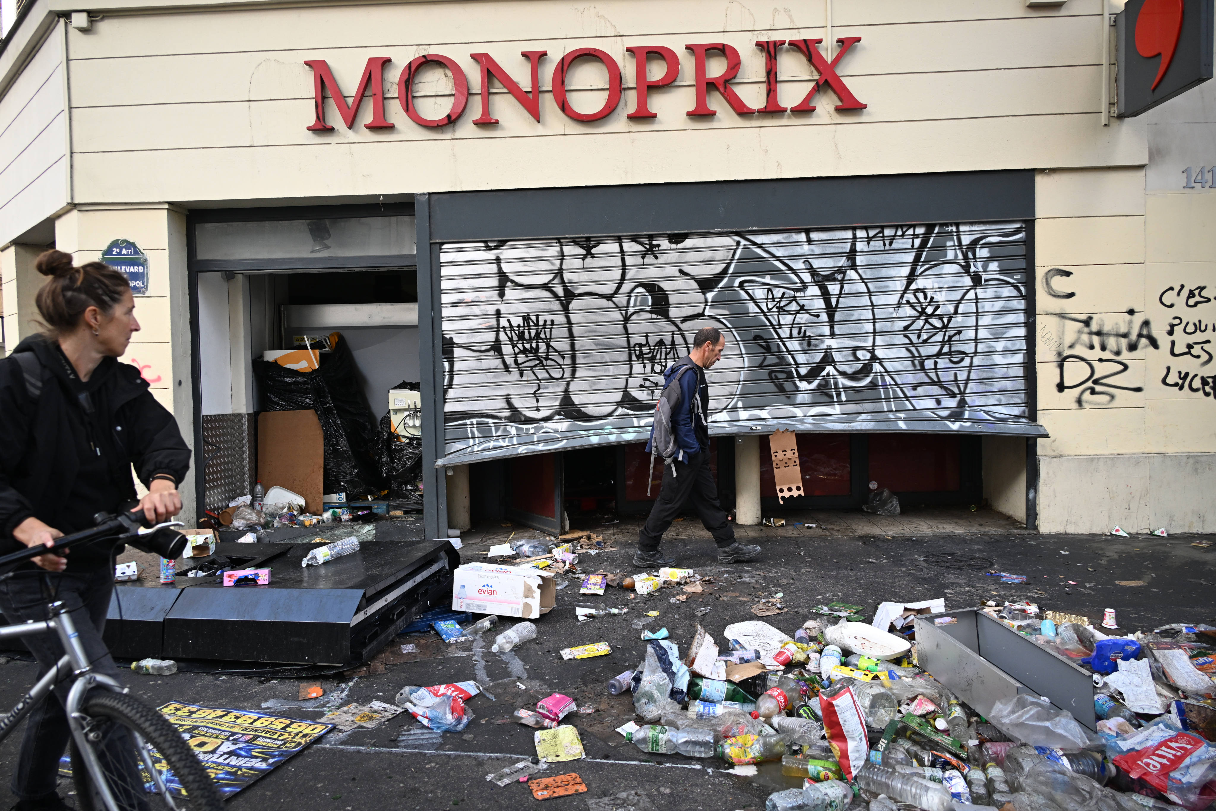A man walks past a looted store the day after a demonstration against rising living costs and in solidarity with students’ grievances in Paris on October 18. Photo: AP