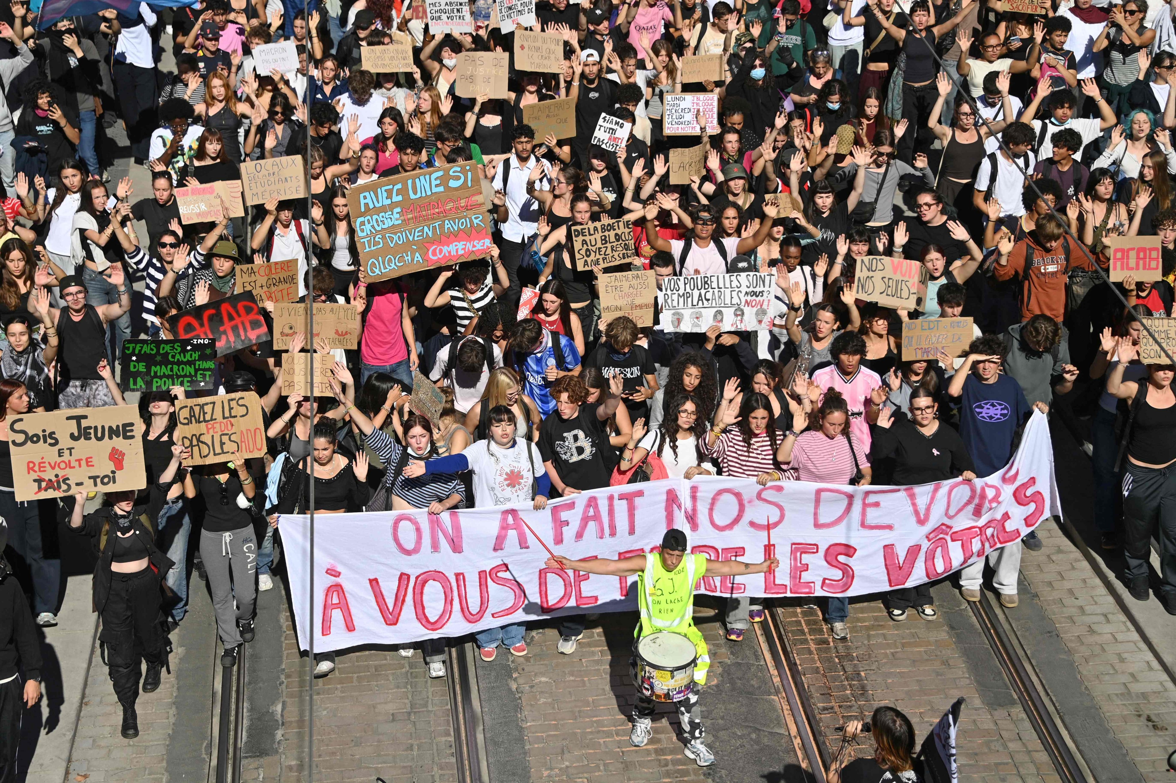 Student protesters hold placards and banners in Montpellier, southern France on October 13, as part of a nationwide high school mobilisation. Photo: AFP