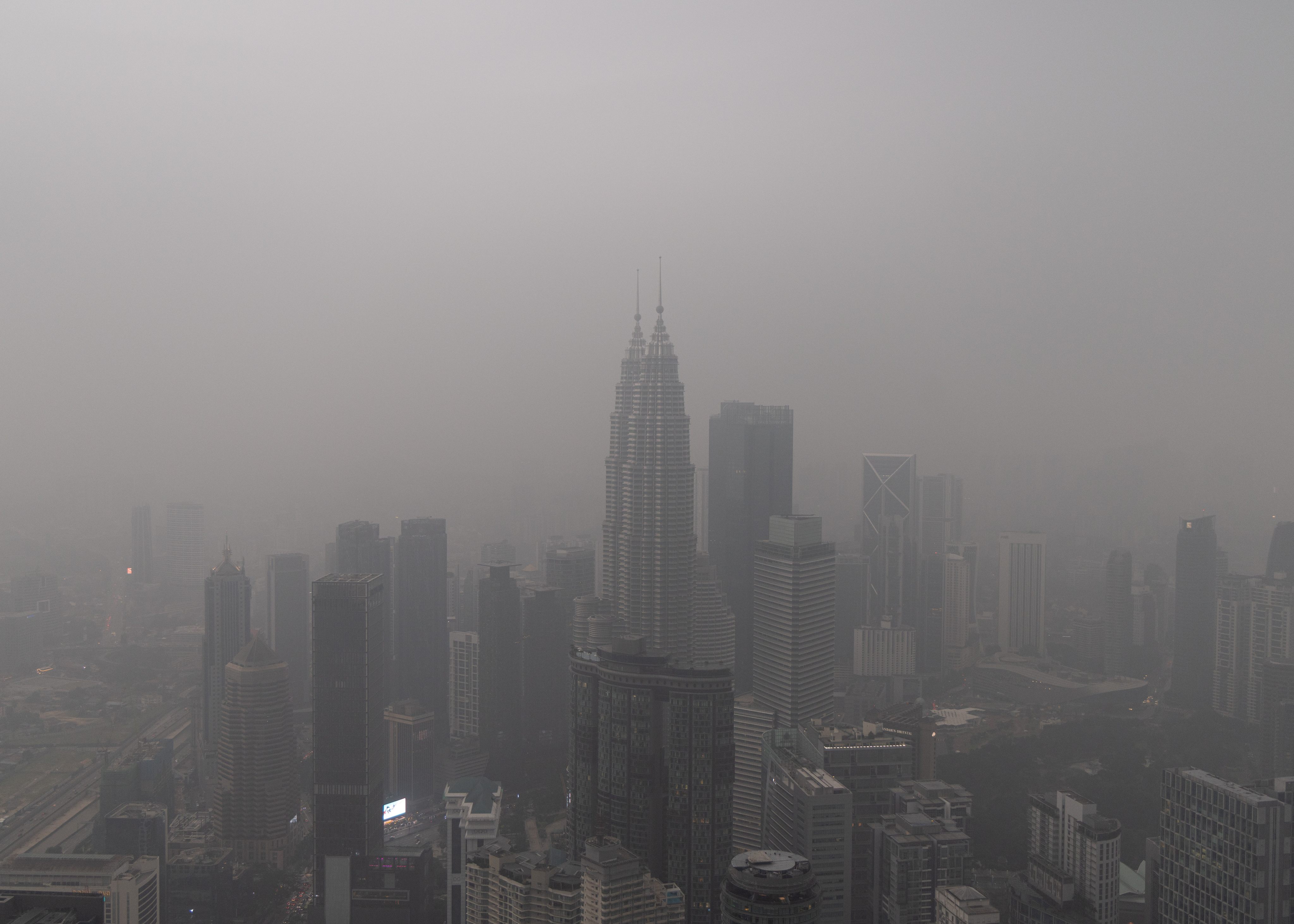 Haze blankets the famous Petronas Twin Towers and the surrounding Kuala Lumpur skyline on Friday. Photo: AP