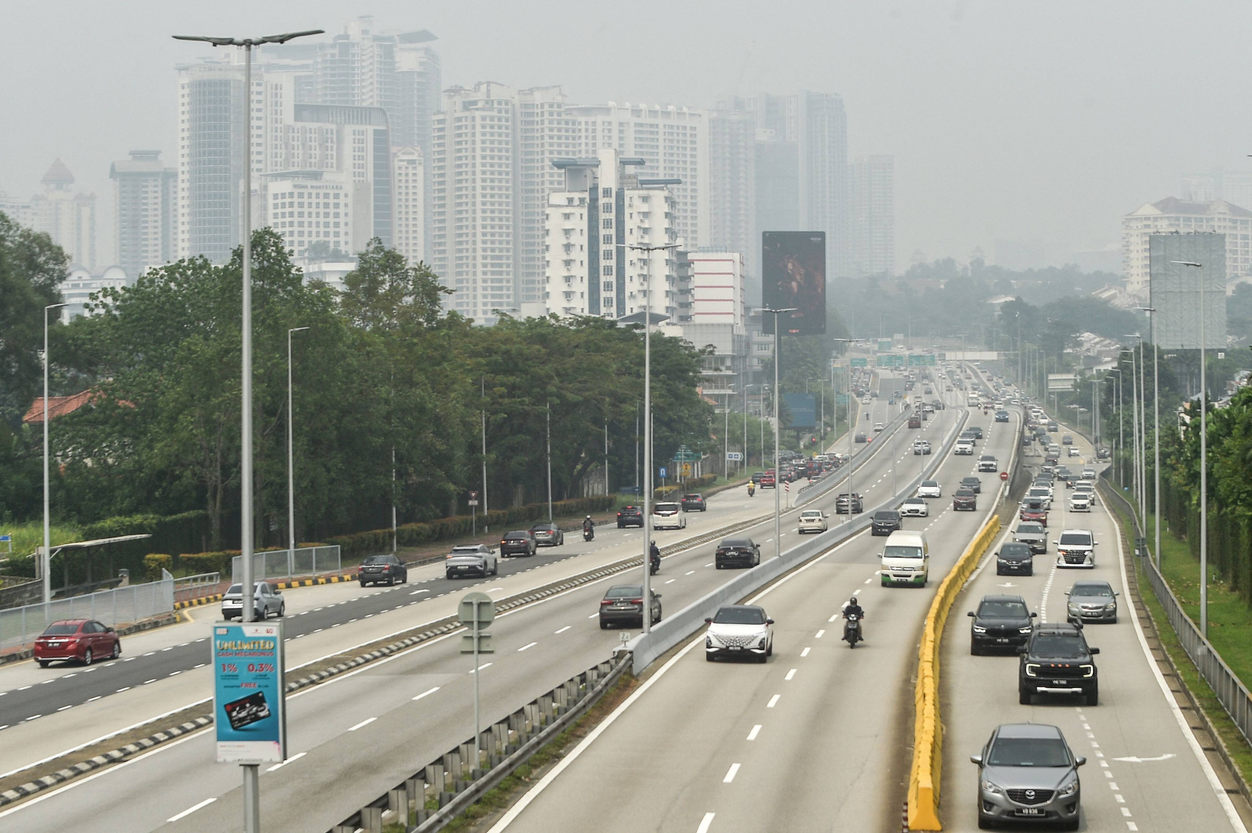 Traffic move along a highway amid hazy condition in Kuala Lumpur on October 9. Photo: AFP