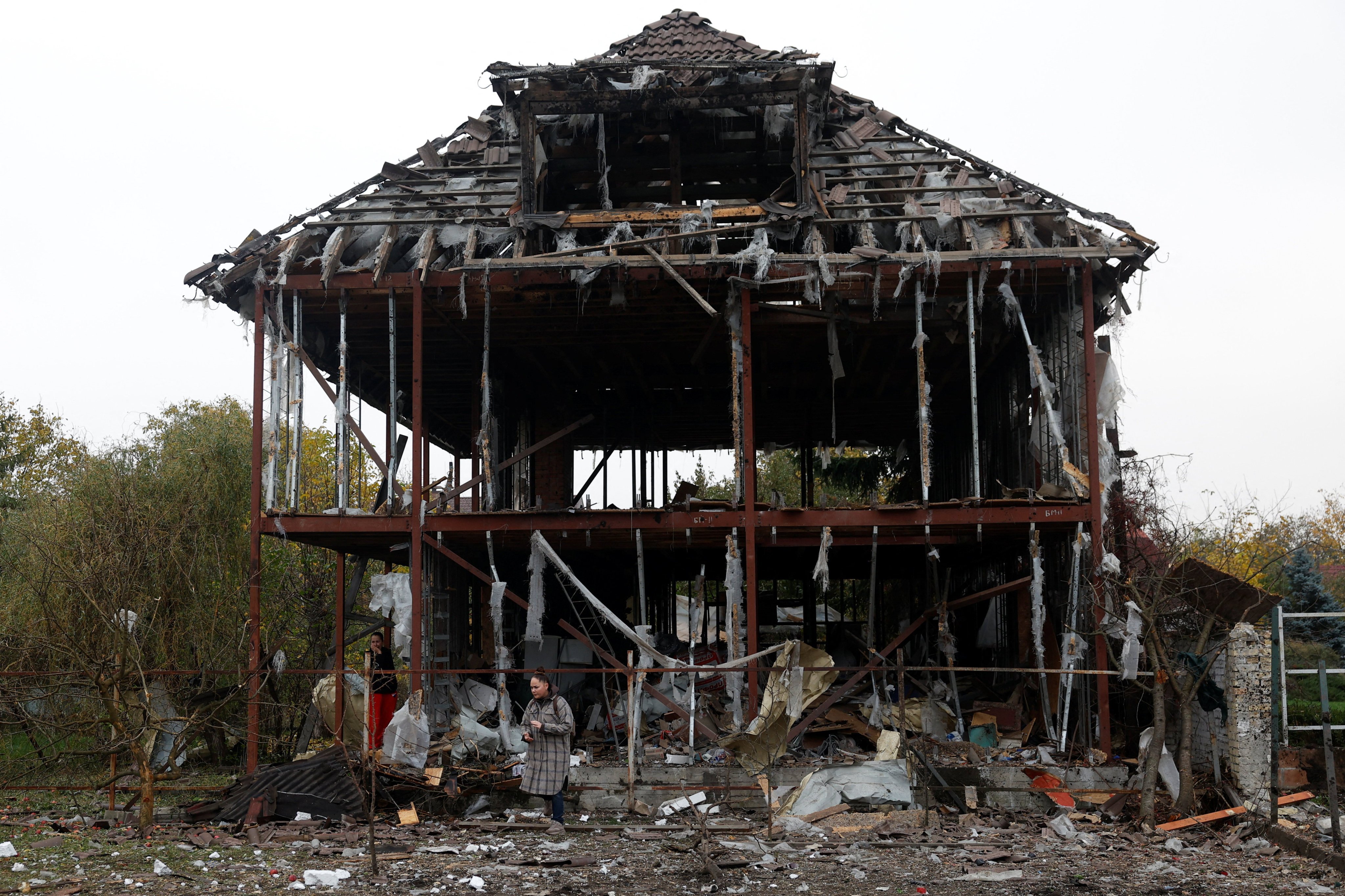 A resident next to her destroyed house in Kyiv. Photo: Reuters