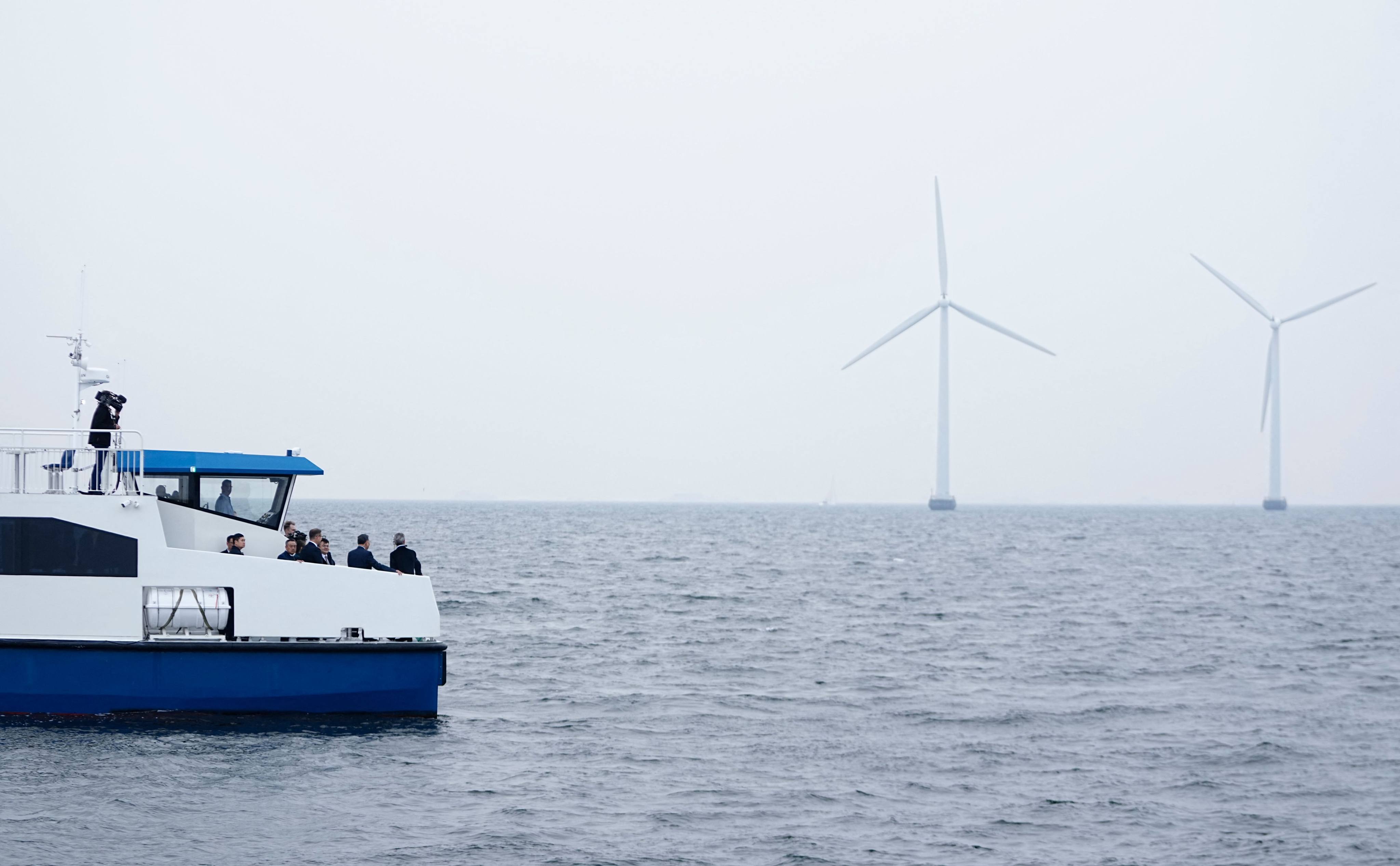 King Frederik X of Denmark (right) and Vietnam’s President To Lam (second right) look at offshore wind turbines as they attend a boat trip in Copenhagen on Wednesday. Photo: AFP
