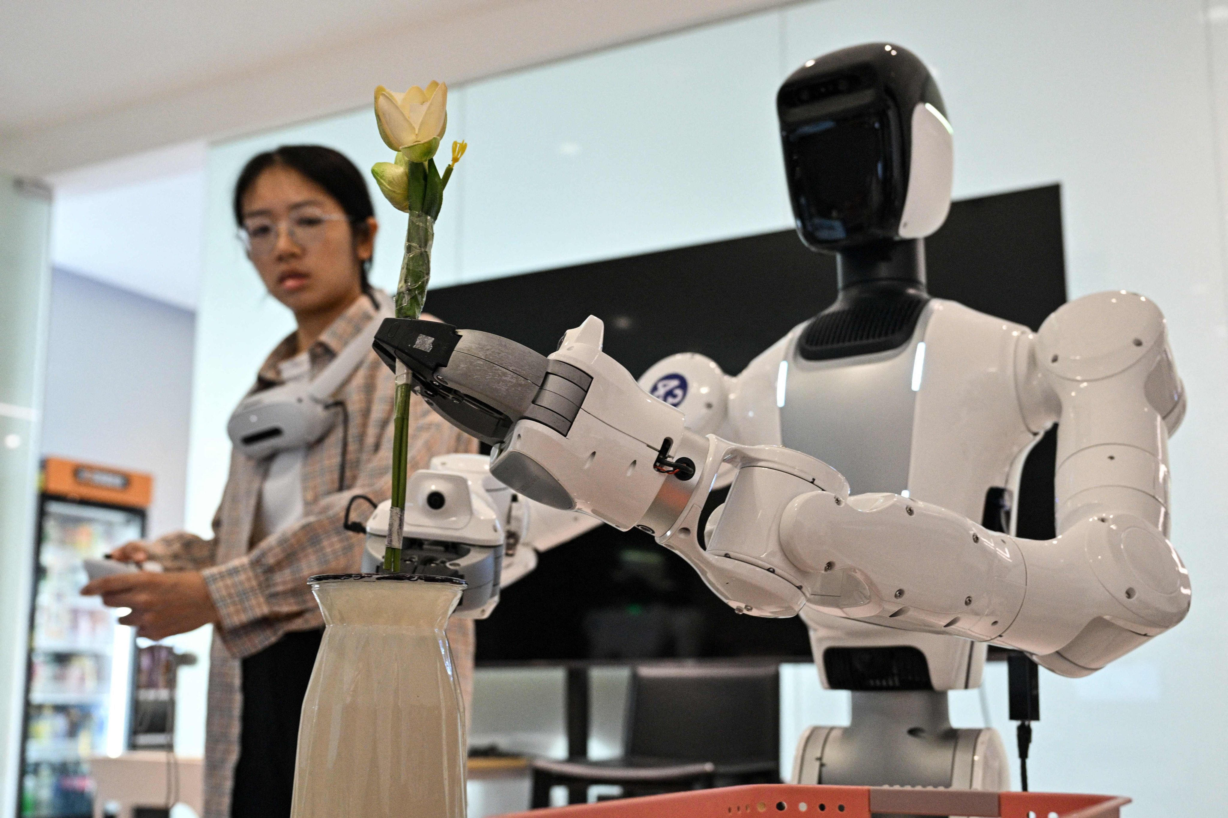 An engineer trains a humanoid robot to do household tasks at facilities in Shenzhen Photo: AFP