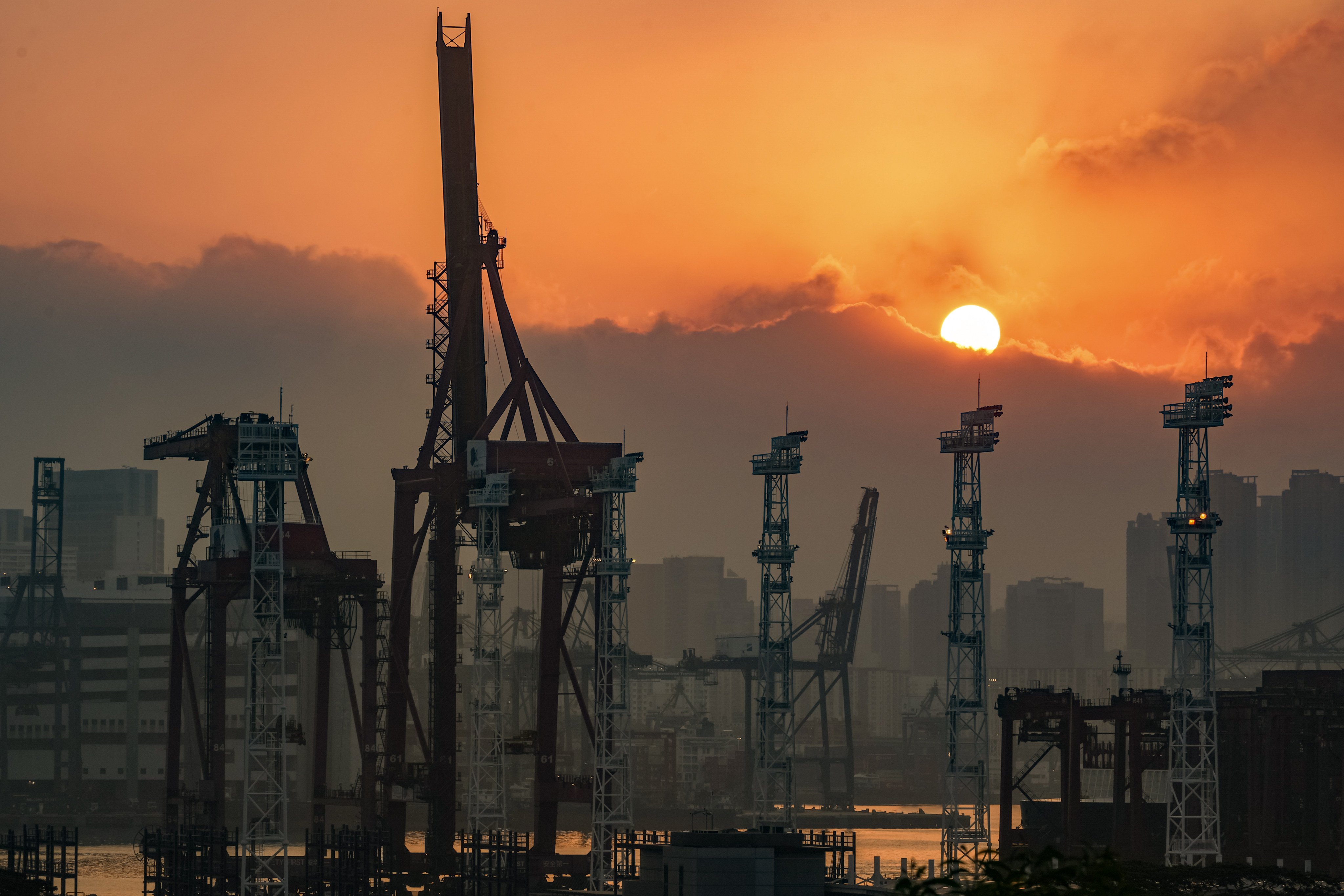 The sun rises behind Kwai Tsing Container Terminals on March 15. Photo: Eugene Lee