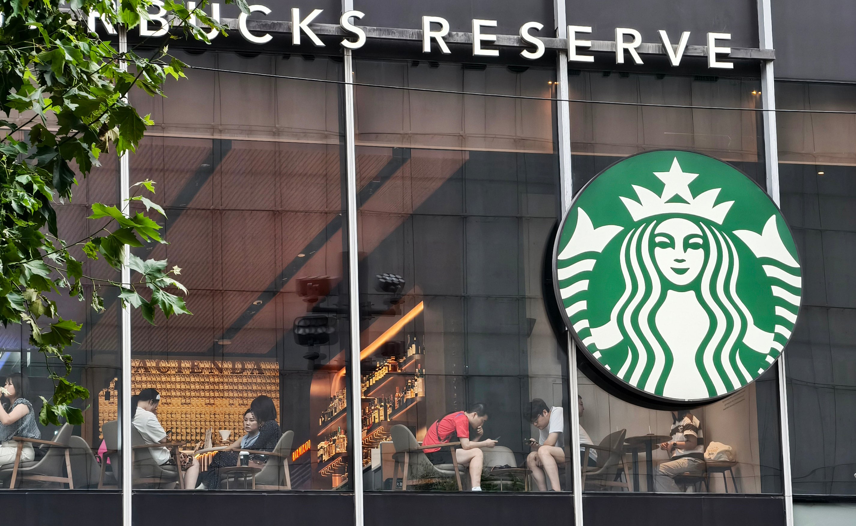 Customers sit in a Starbucks store in Shanghai. Photo: Getty Images