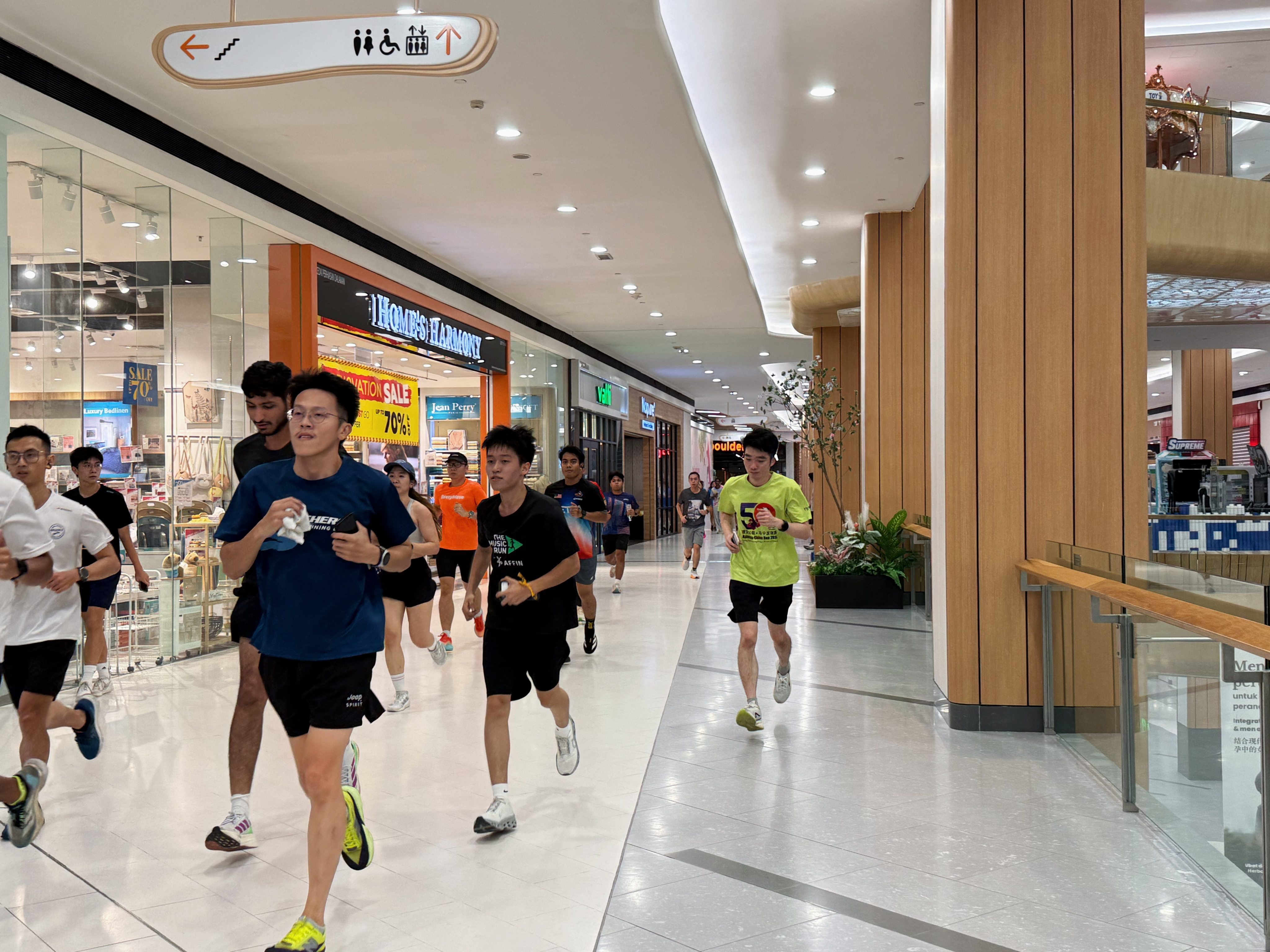 Runners make their way past shopfronts at Atria Shopping Gallery in Petaling Jaya, Malaysia, on Wednesday,  as worsening haze drives fitness enthusiasts indoors. Photo: Iman Muttaqin Yusof