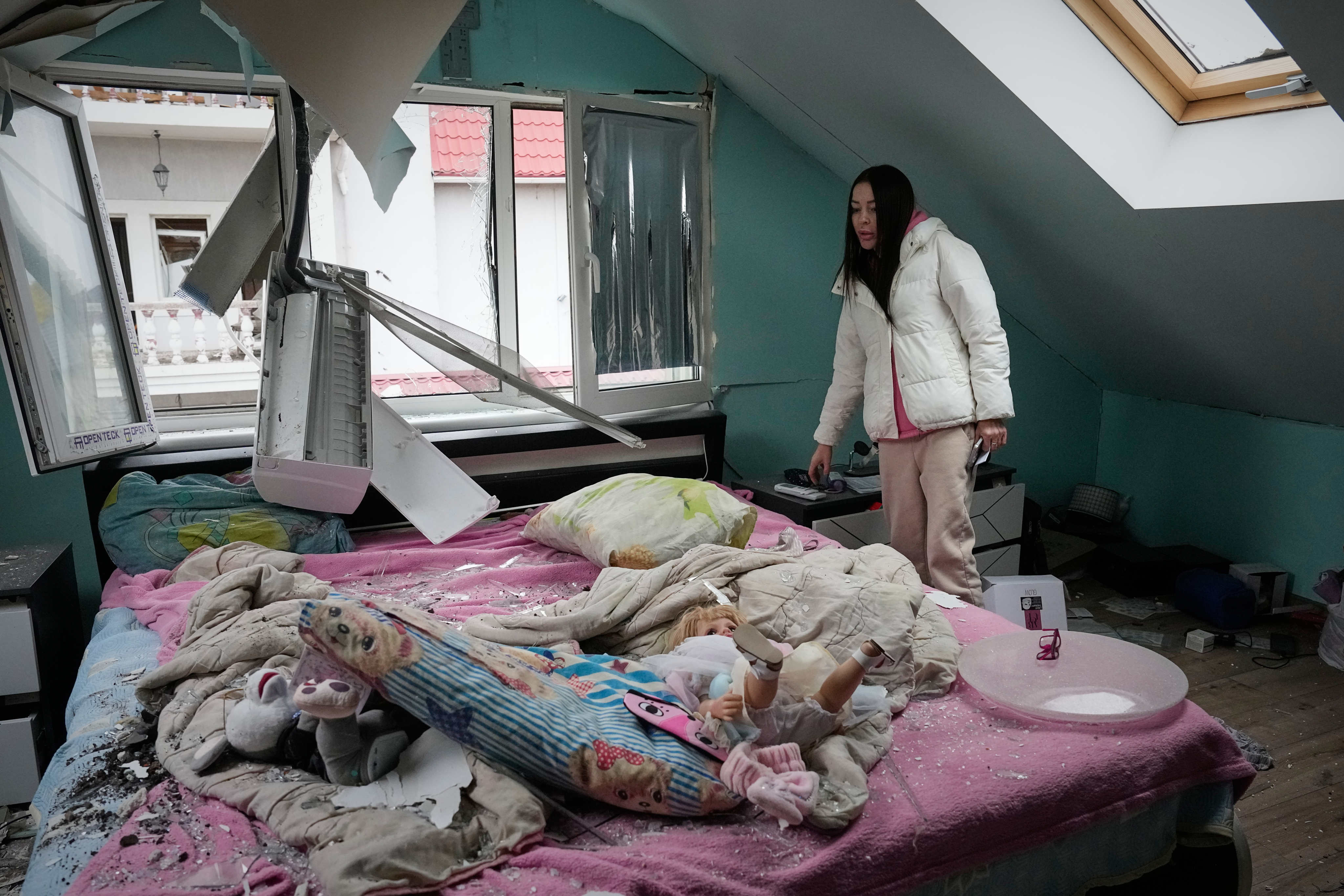 A woman inside her damaged flat in Kyiv. Photo: AP
