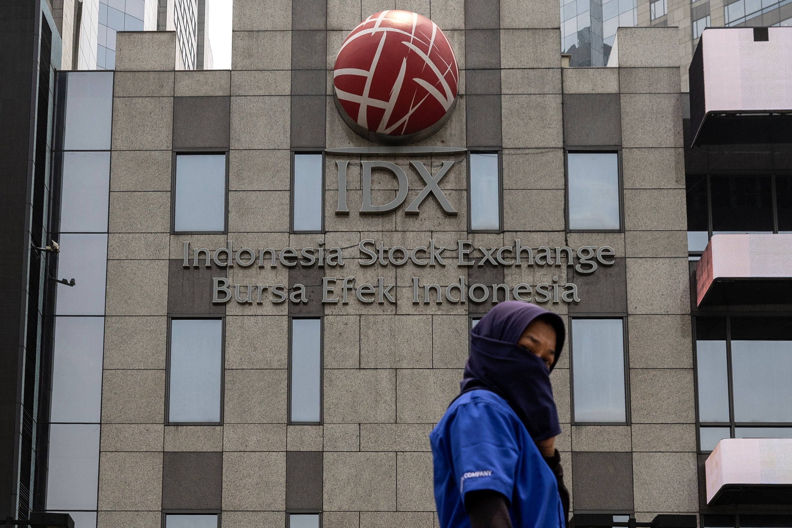 A woman walks past the Indonesia Stock Exchange building in Jakarta on Wednesday. Photo: Reuters