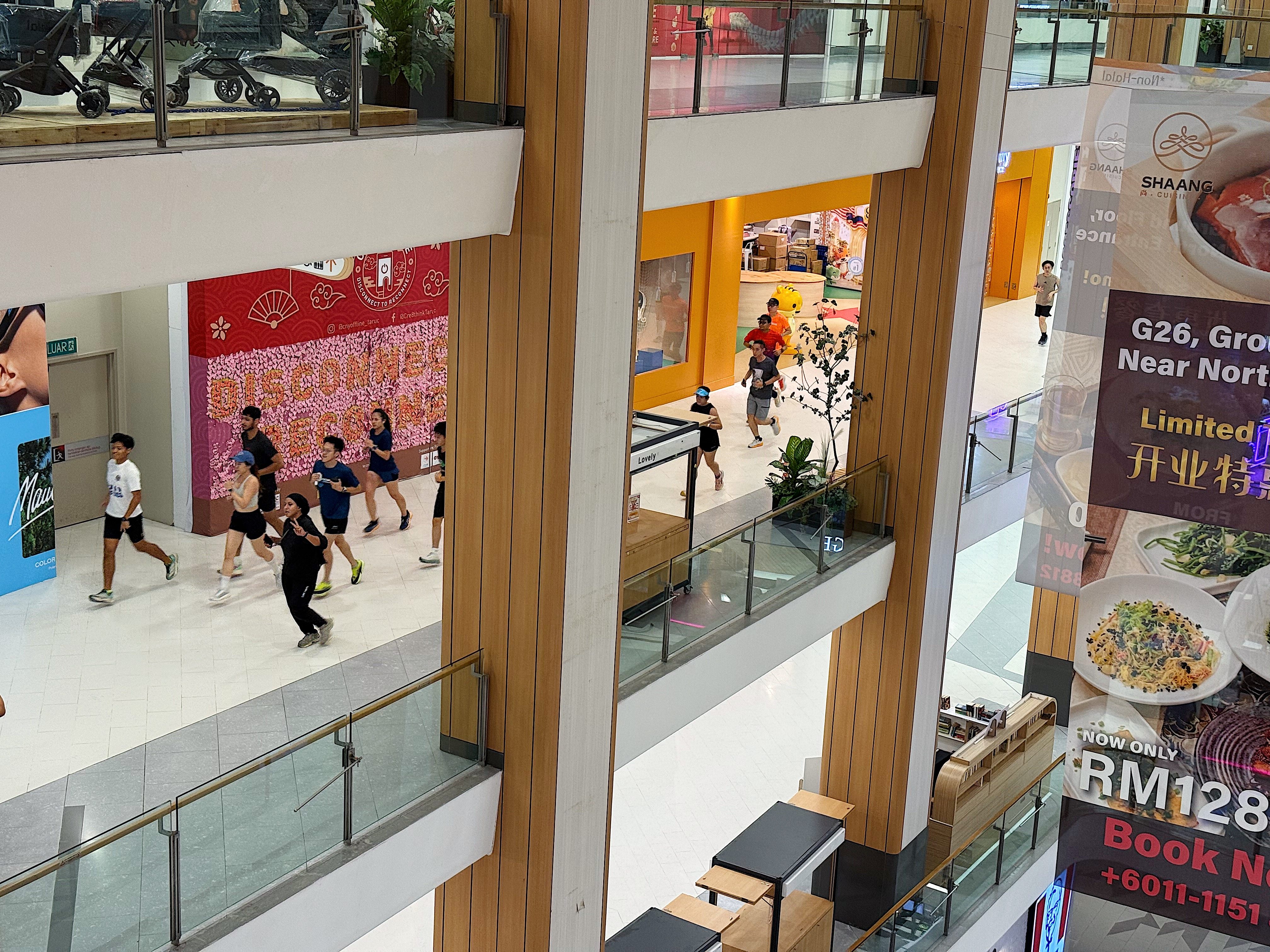 Runners clock up laps along the upper floors of Atria Shopping Gallery in Petaling Jaya, Malaysia, during an organised indoor run on Wednesday. Photo: Iman Muttaqin Yusof