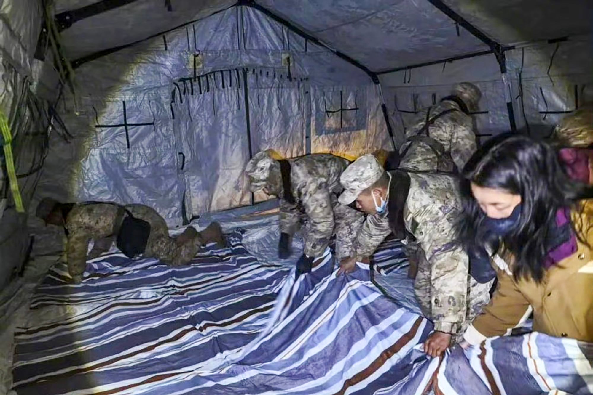 Soldiers set up tents and temporary food supply stations in Baqing county, where more than 300 homes collapsed when an earthquake struck the mountainous area in China’s Tibet autonomous region on Thursday night. Photo: Xinhua