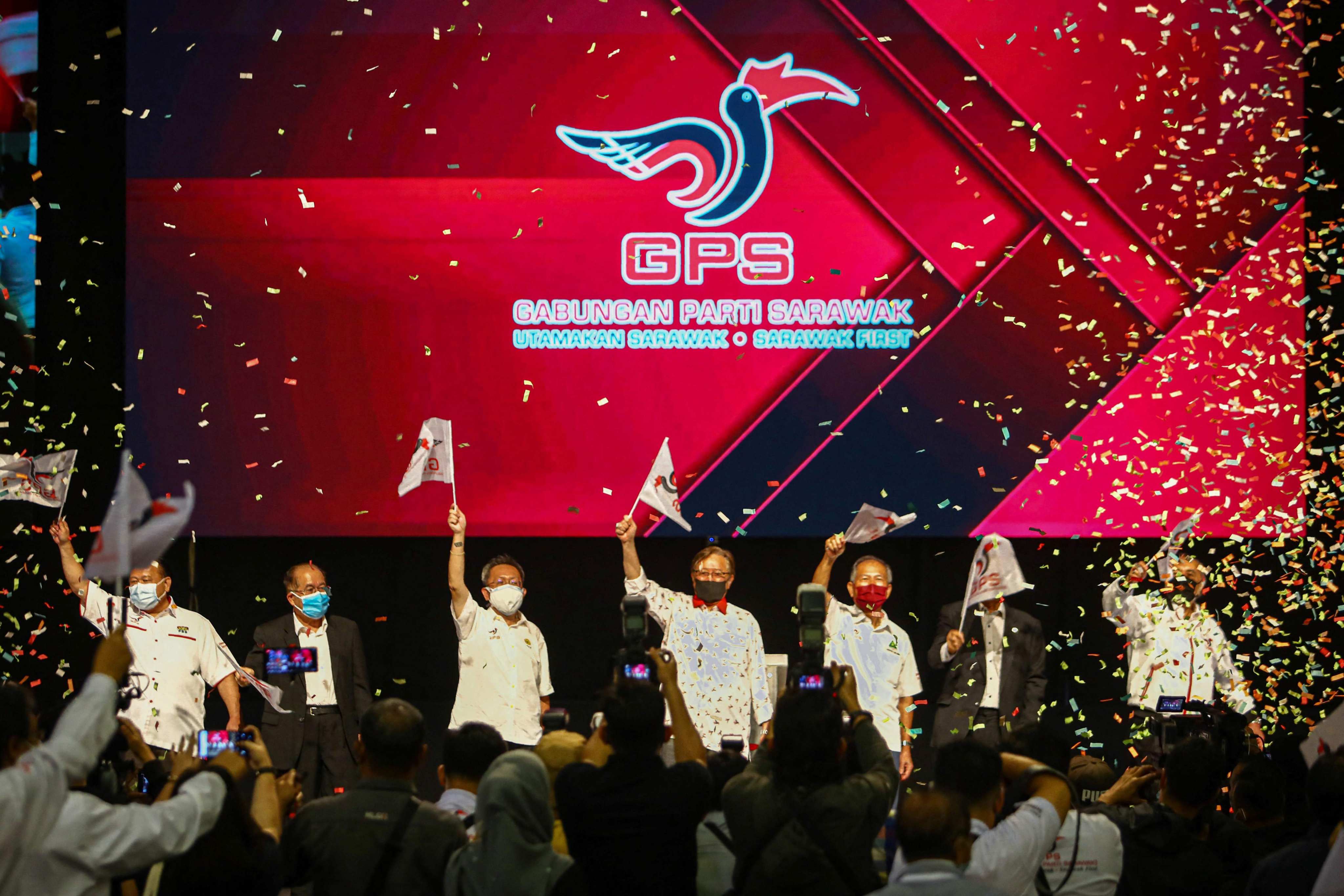 Leaders of the Sarawak Parties Alliance coalition wave flags after their landslide victory in the state elections in Kuching in 2021. The alliance currently holds 80 of the 82 seats in the state legislature. Photo: AFP