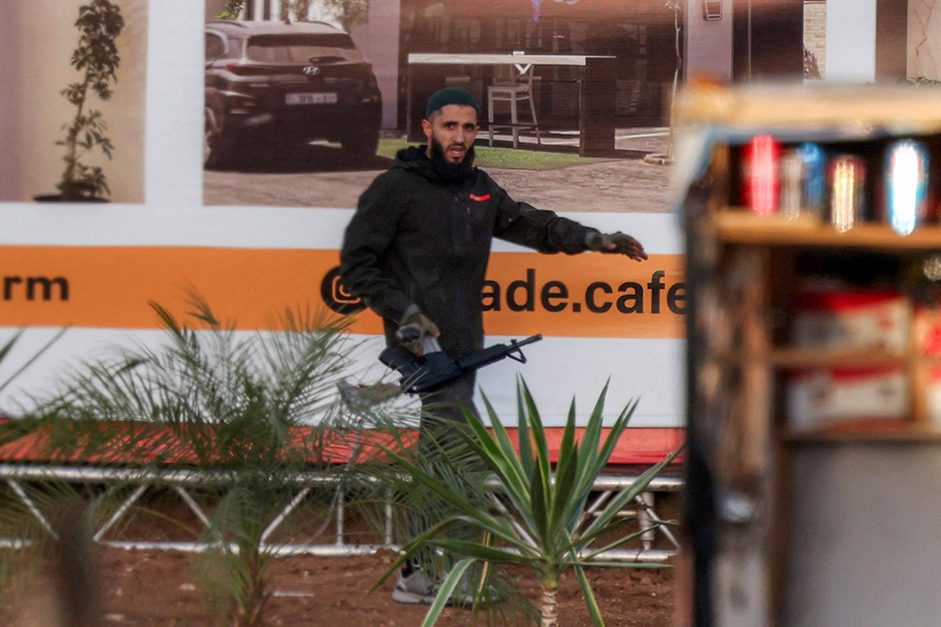 An armed Palestinian assailant carries an assault rifle during the gun battle. Photo: AFP
