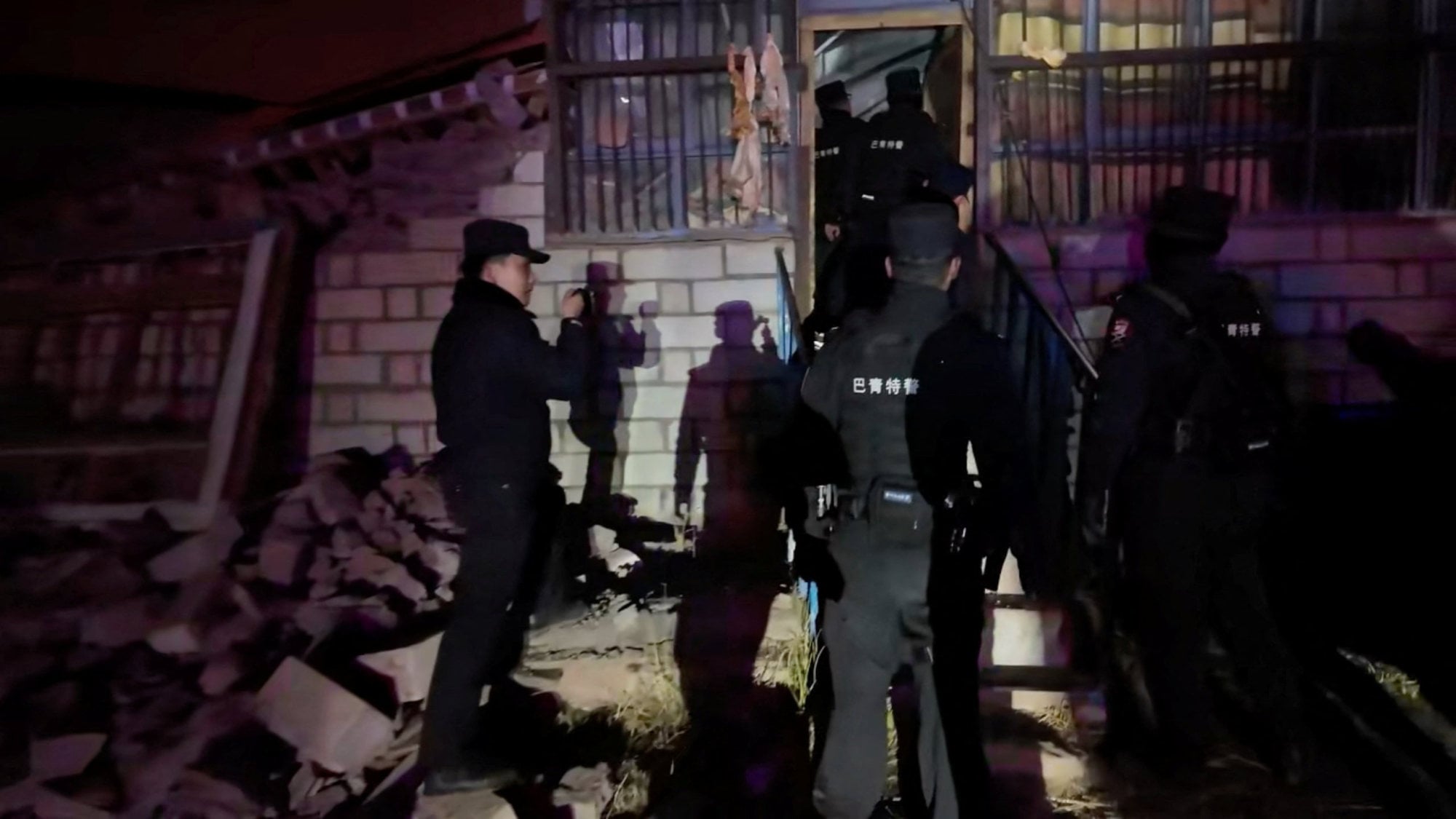 Emergency services personnel inspect a damaged building following Thursday night’s earthquake. Photo: Reuters