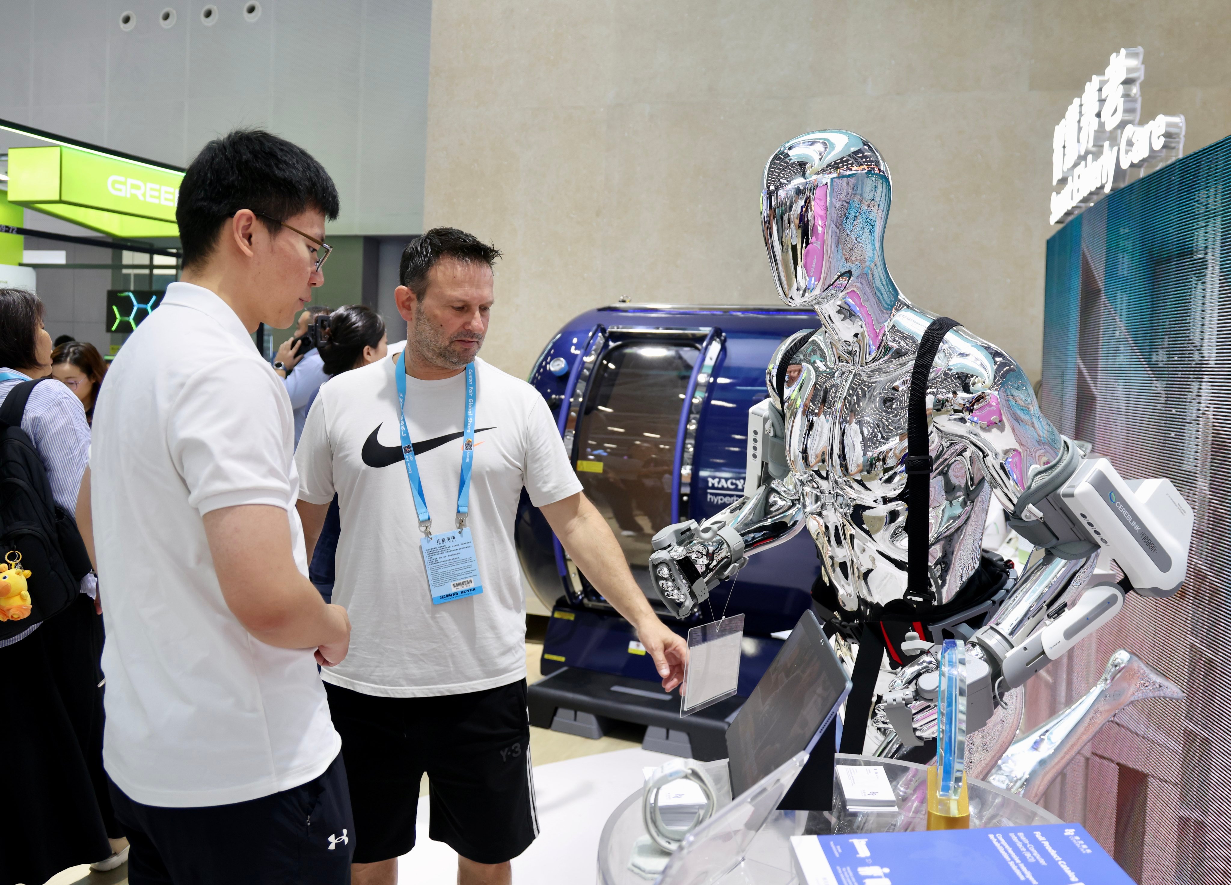 A buyer inspects smart healthcare equipment on display at the Canton Fair in Guangzhou. Photo: Xinhua