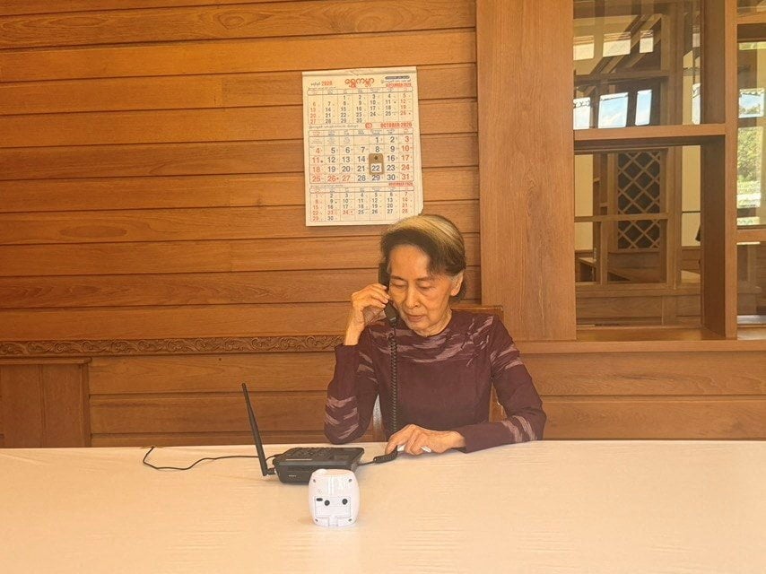 Myanmar’s former leader Aung San Suu Kyi talks on the phone to her son, Kim Aris on Thursday. Photo: Myanmar Presidential Press Office /  Reuters