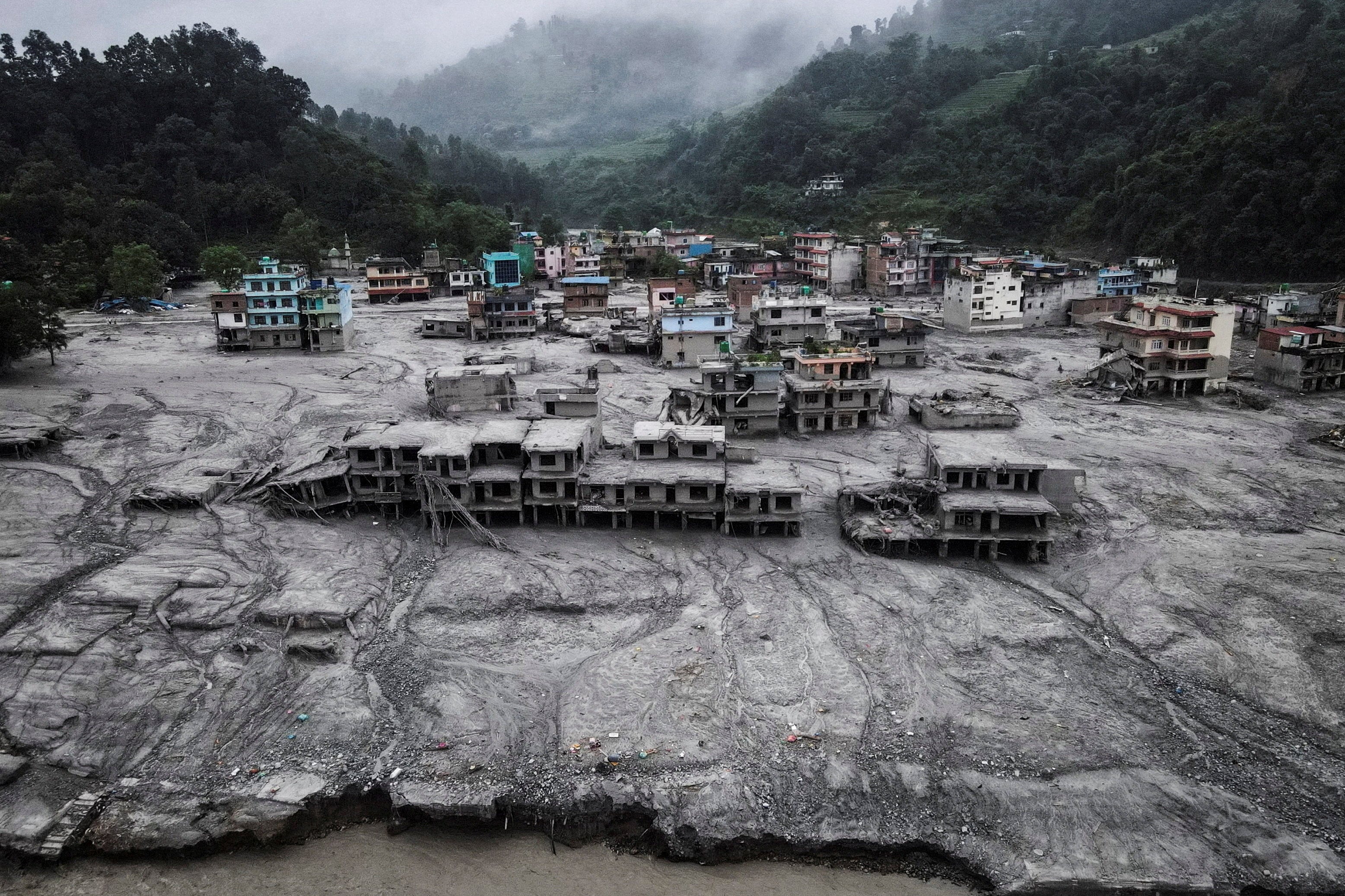 A drone view shows houses covered in mud after Nepal’s flash floods and mudslide at Devighat on August 29. Photo: Reuters