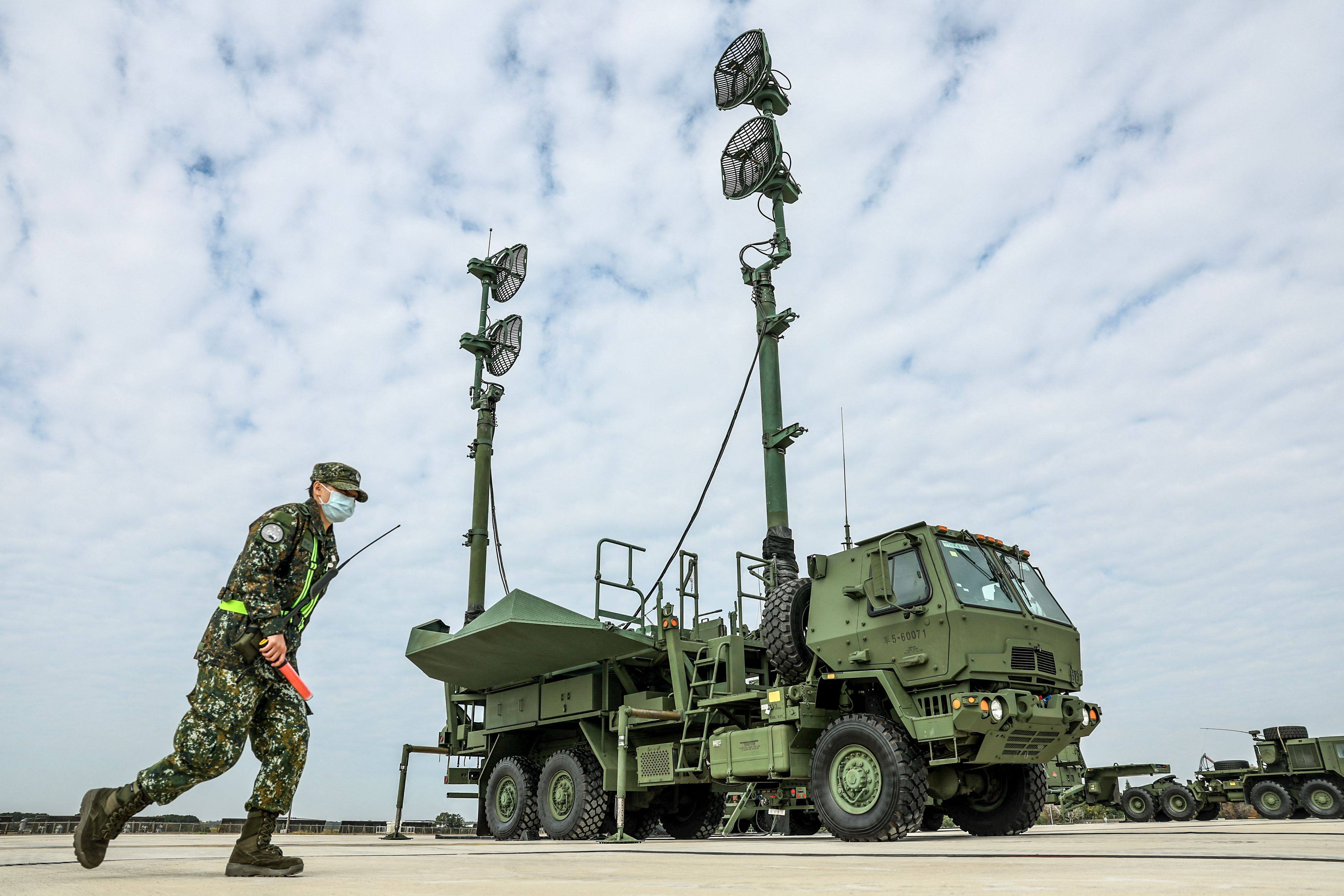 A Taiwanese soldier walks past a mobile system that carries the antennas and amplifiers for the Patriot missile system during an exercise at Ching Chuan Kang Air Base in Taichung in January 2025. Photo: AFP