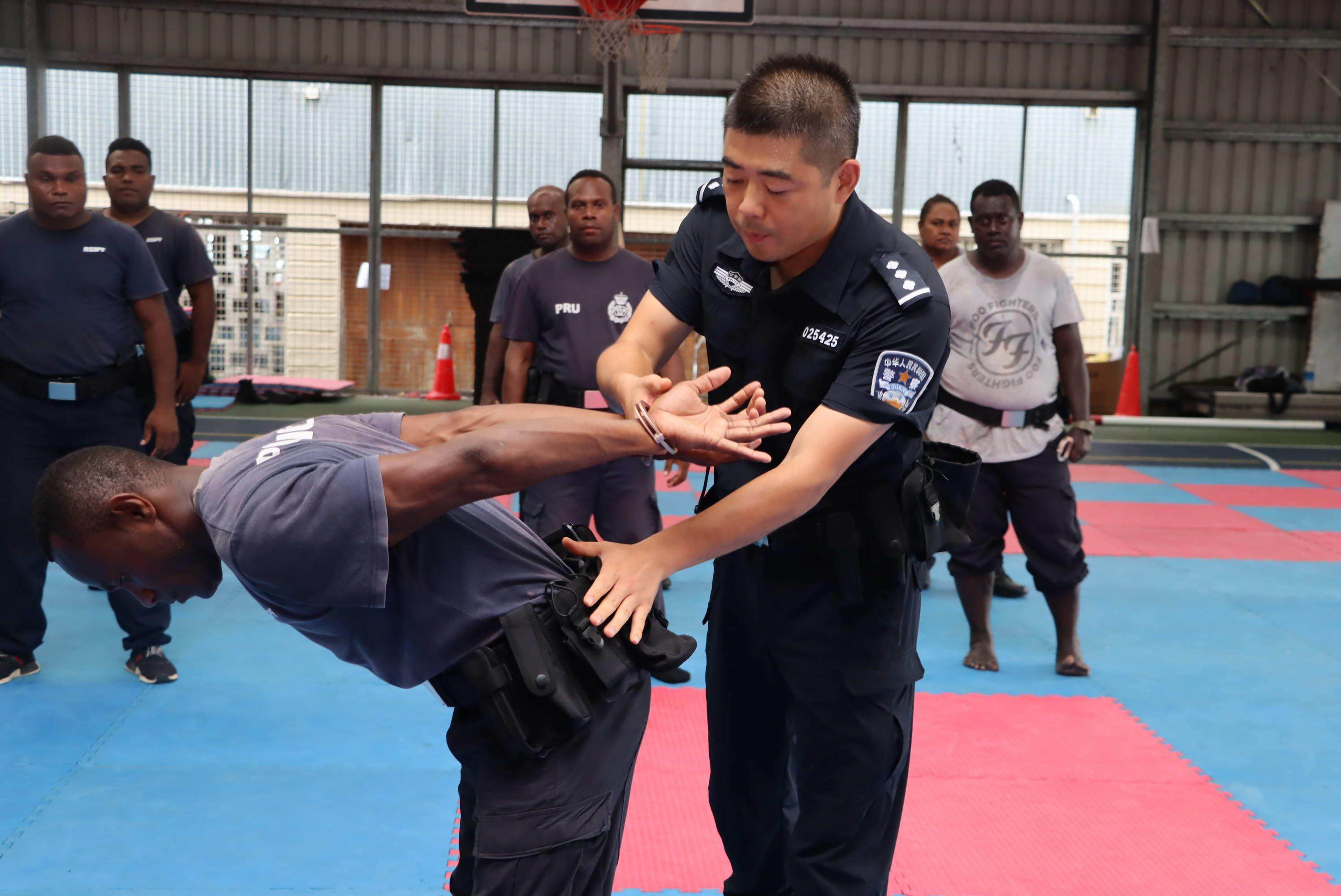 A Chinese police officer demonstrates a restraint technique during a training session with Solomon Islands police. Photo: Handout