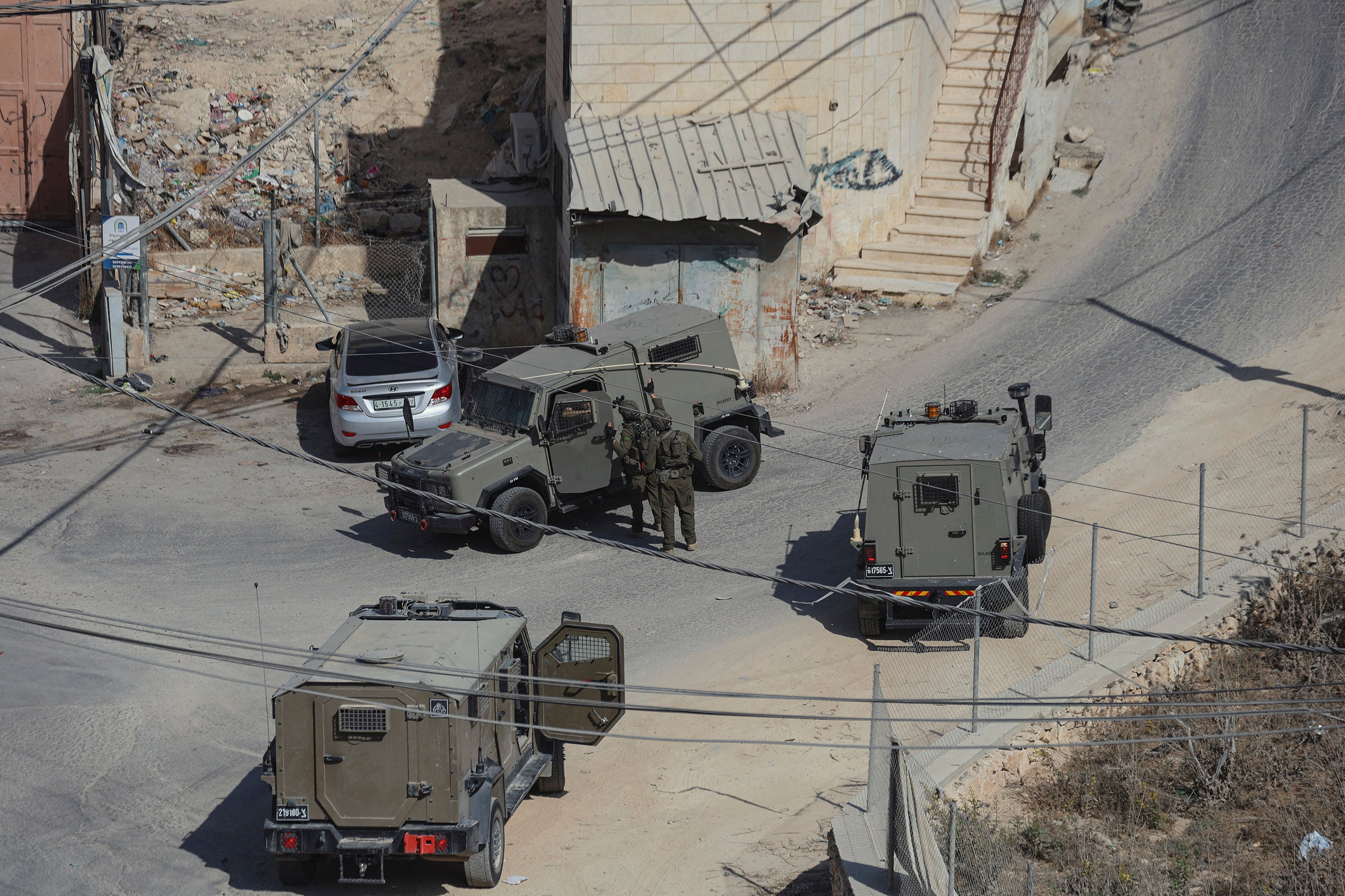 Israeli military vehicles on a street in Hebron in the occupied West Bank on Friday. Photo: TNS