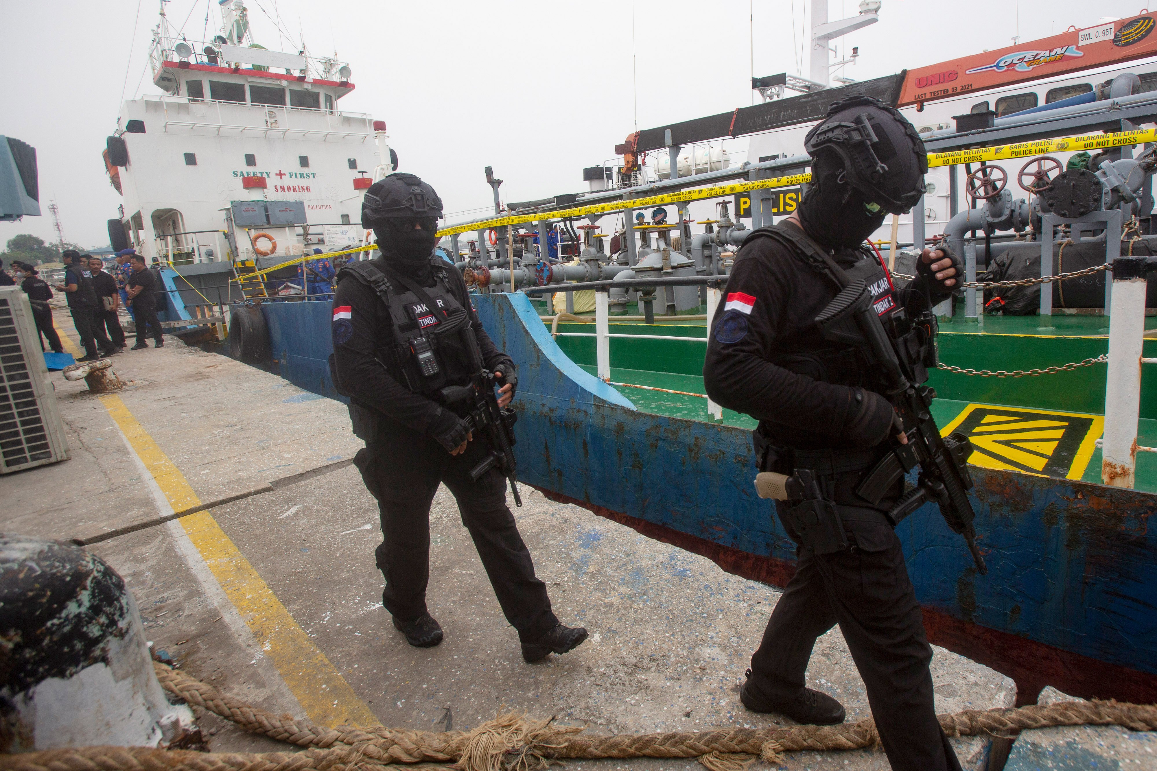 Officers of the National Narcotics Agency walk near the Mongolian-flagged tanker MT Global 168 following the seizure of more than one tonne of ketamine from the ship, in Belawan, North Sumatra, Indonesia, on Friday. Photo: AP
