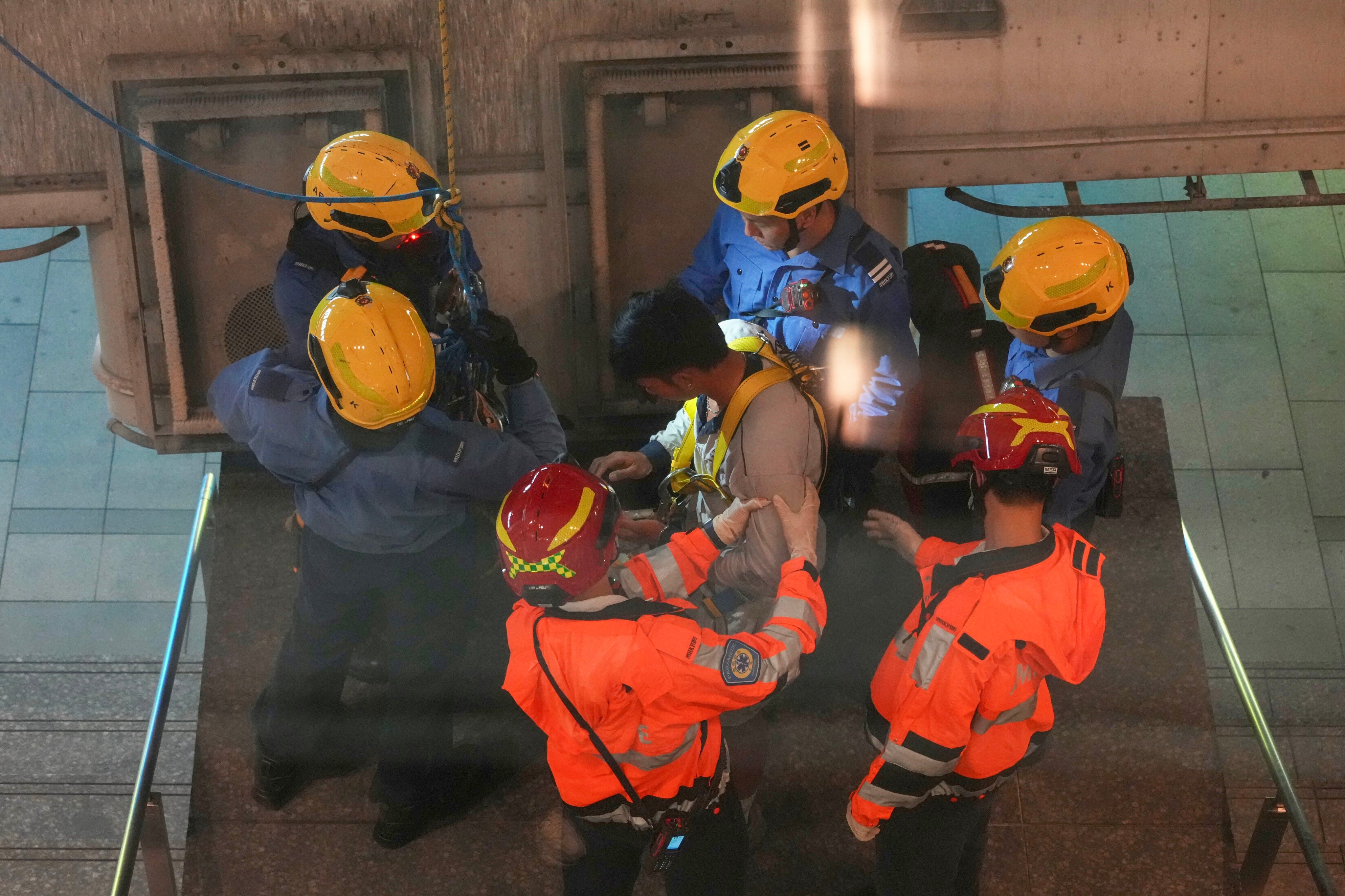 One of the workers was helped to safety at around 7.40pm. Photo: Karma Lo