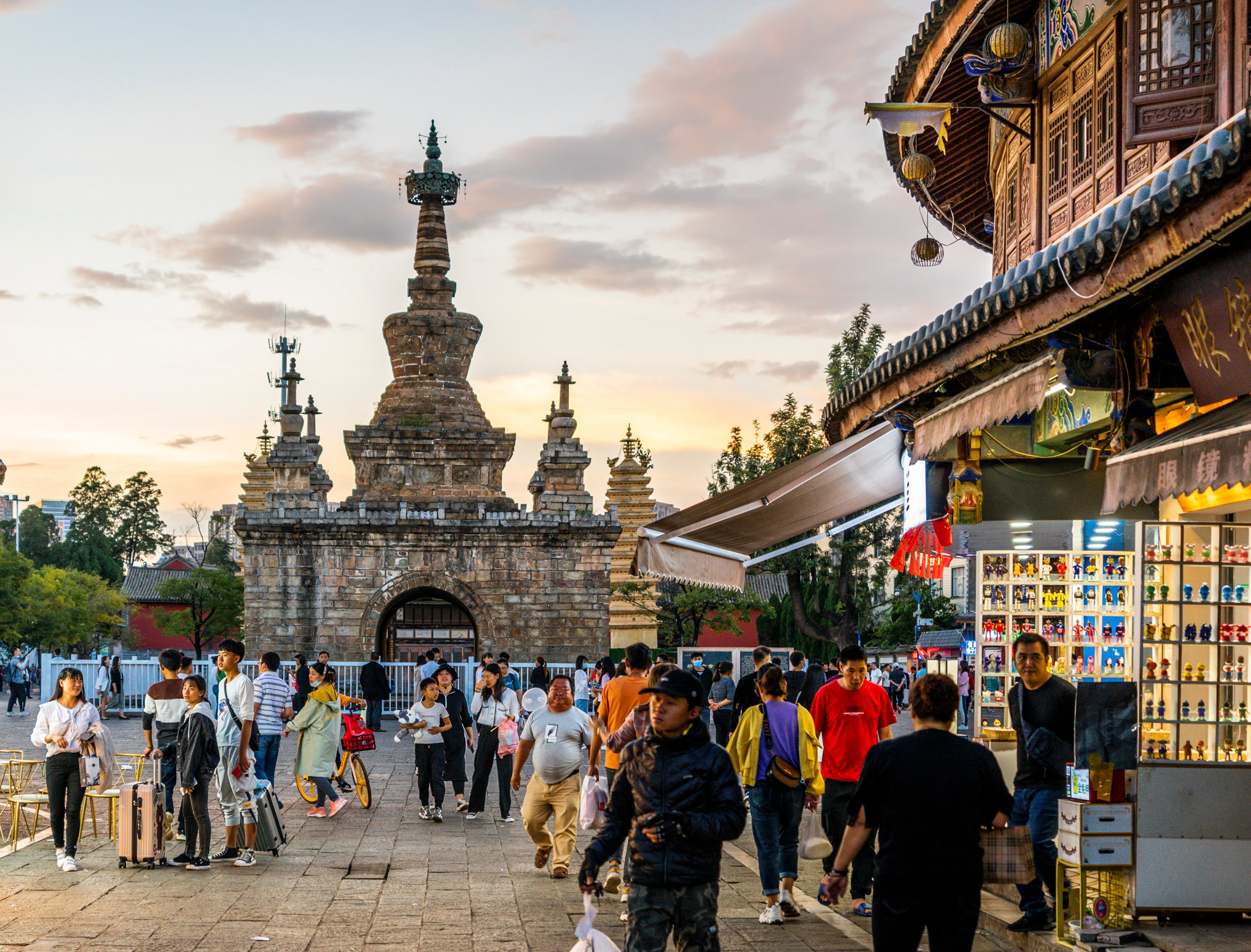 Visitors walk on a scenic street in Kunming’s Guandu Ancient Town with the Jingang Pagoda in the background. From historic sites to delicious local food and markets, here are some of the best things to do and see in the capital of China’s Yunnan province on a weekend trip. Photo: Shutterstock