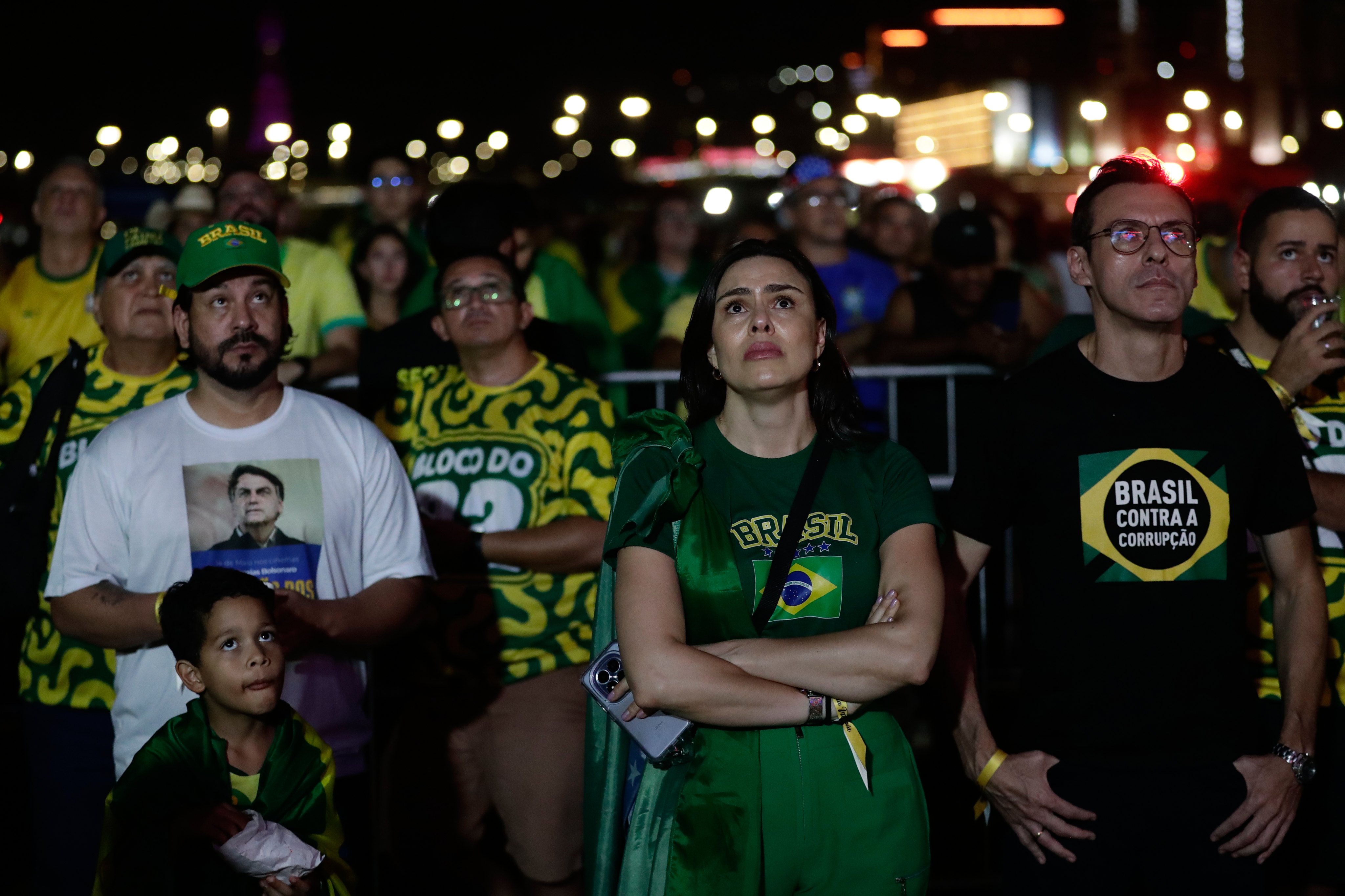 Supporters of opposition presidential candidate Senator Flavio Bolsonaro react to the results. Photo: AP