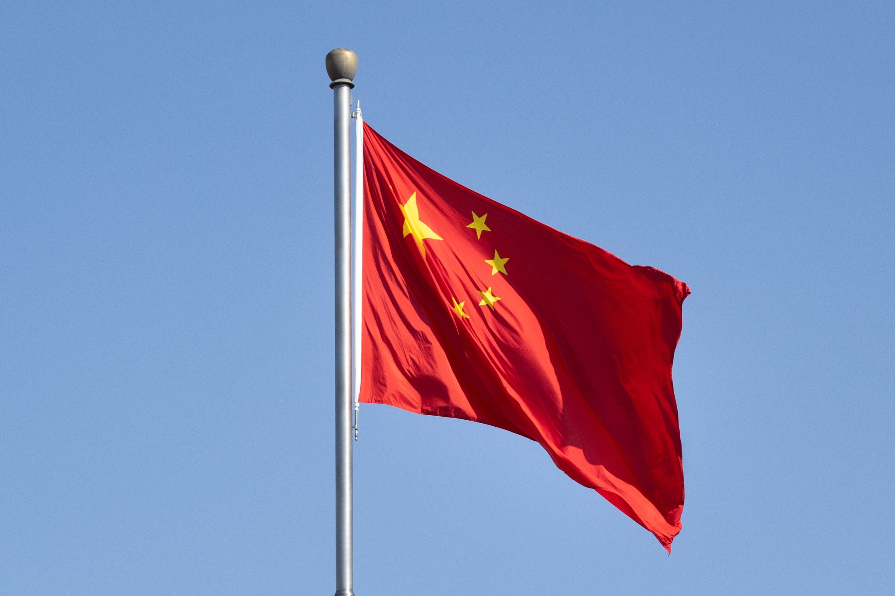 A Chinese national flag flutters in the wind in Beijing. Photo: EPA