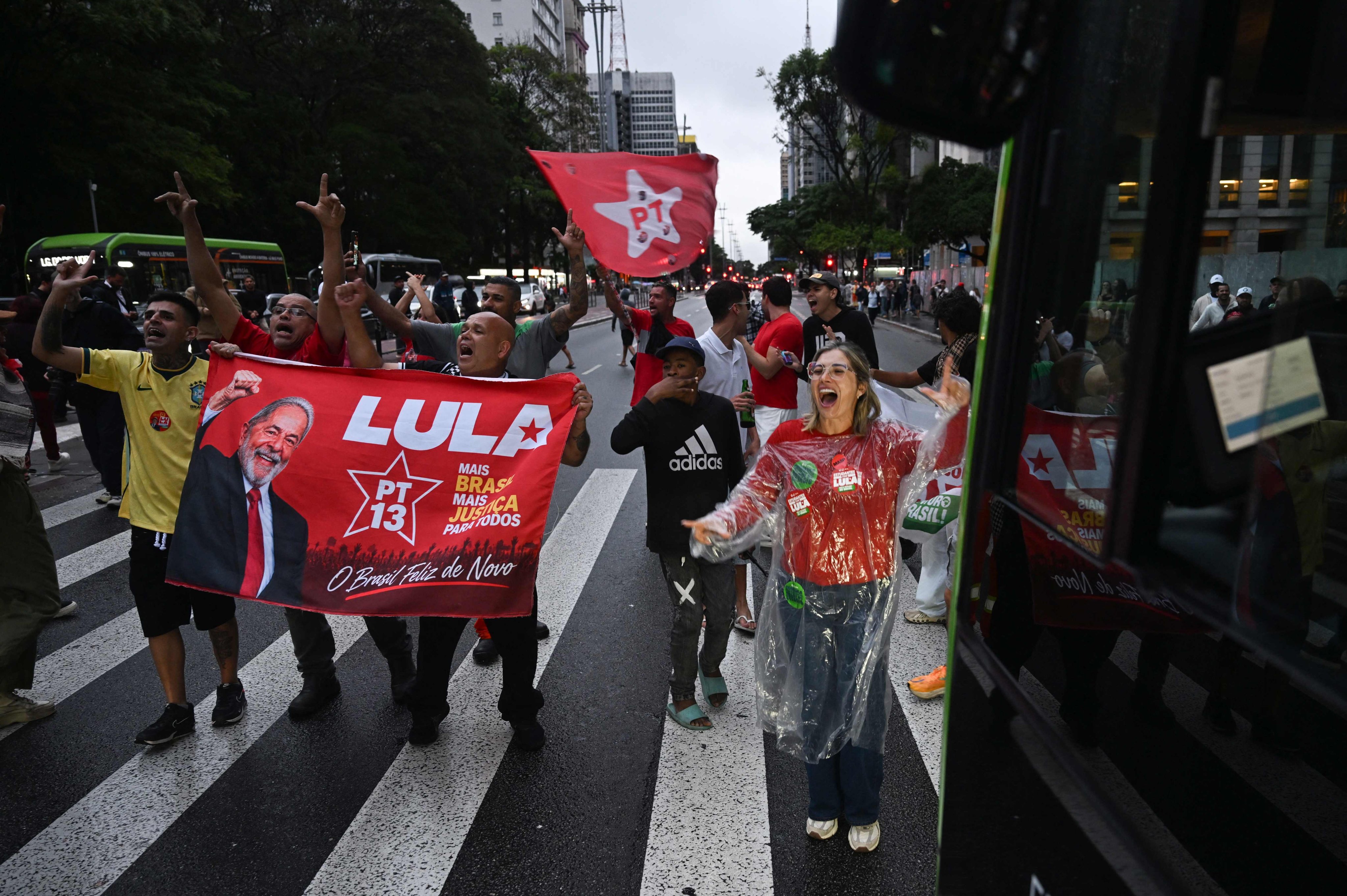 Supporters of Brazil’s President Luiz Inacio Lula da Silva wave a flag in Sao Paulo state, Brazil on Sunday. Photo: AFP
