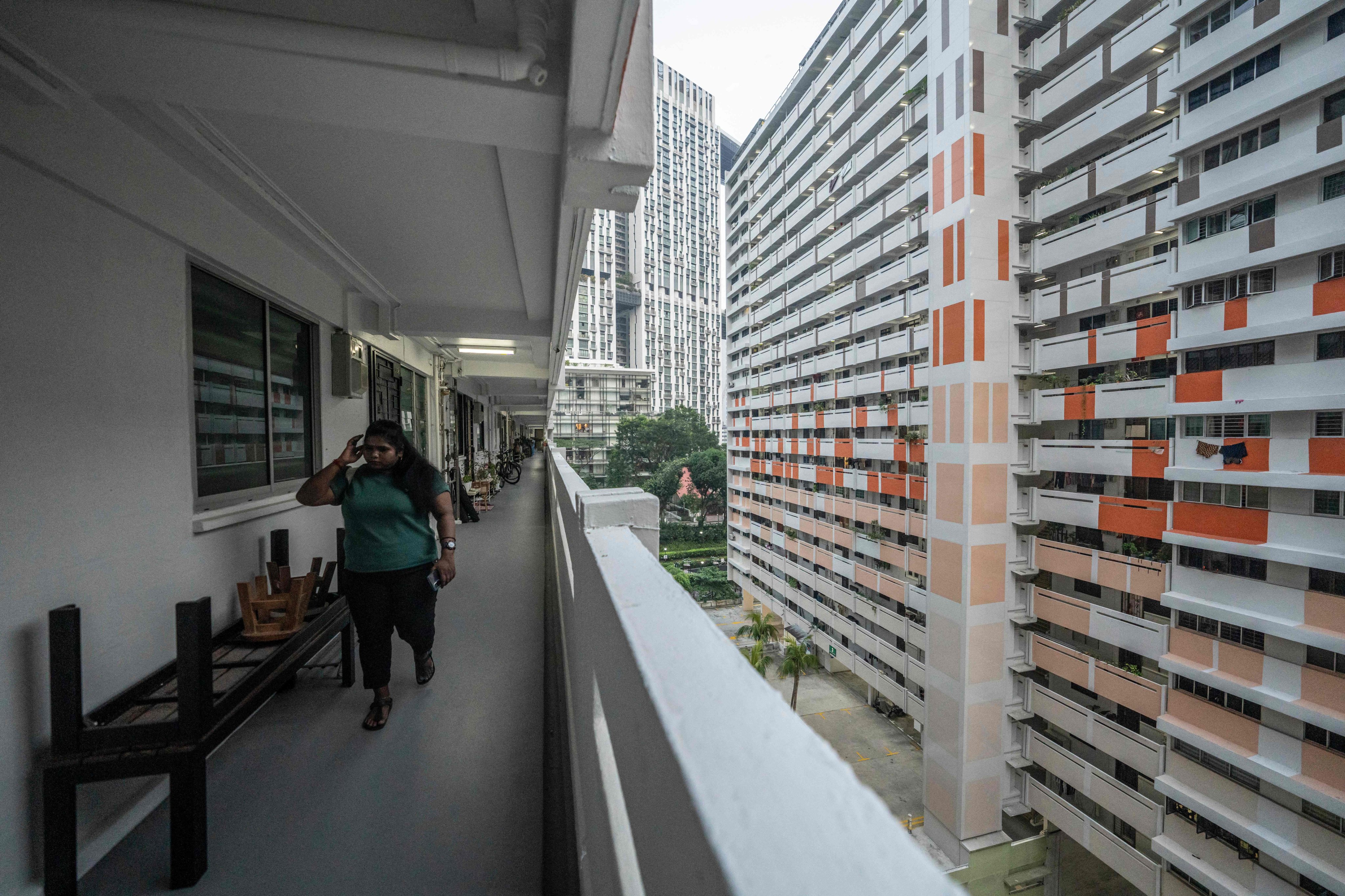 A woman walks along the corridor of a public housing block in Singapore on October 19, as the country continues to be shrouded in haze. Photo: AFP