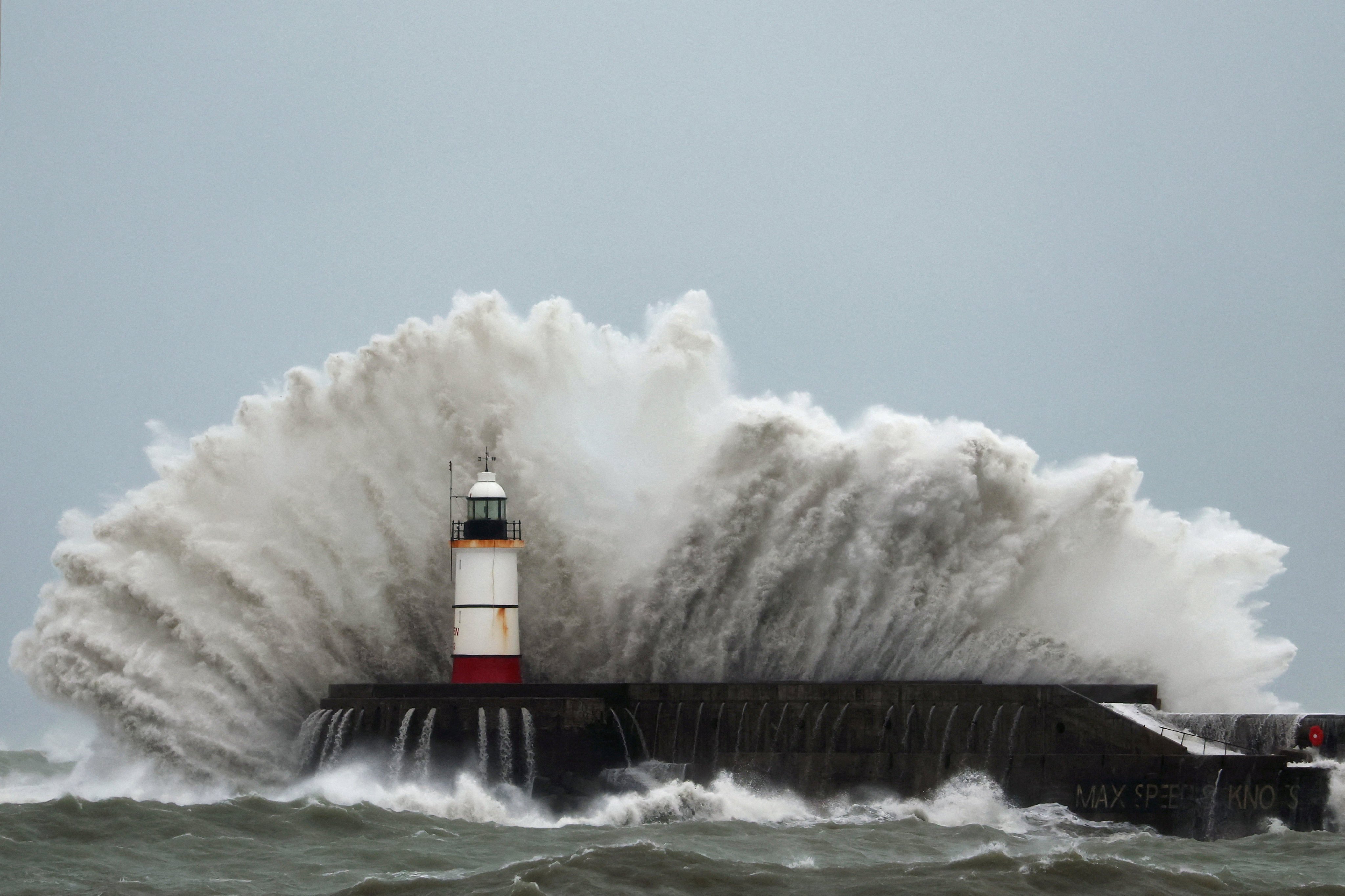 Waves crash over the breakwater lighthouse at Newhaven Harbour during Storm Austen on the southern coast of England. Photo: Reuters