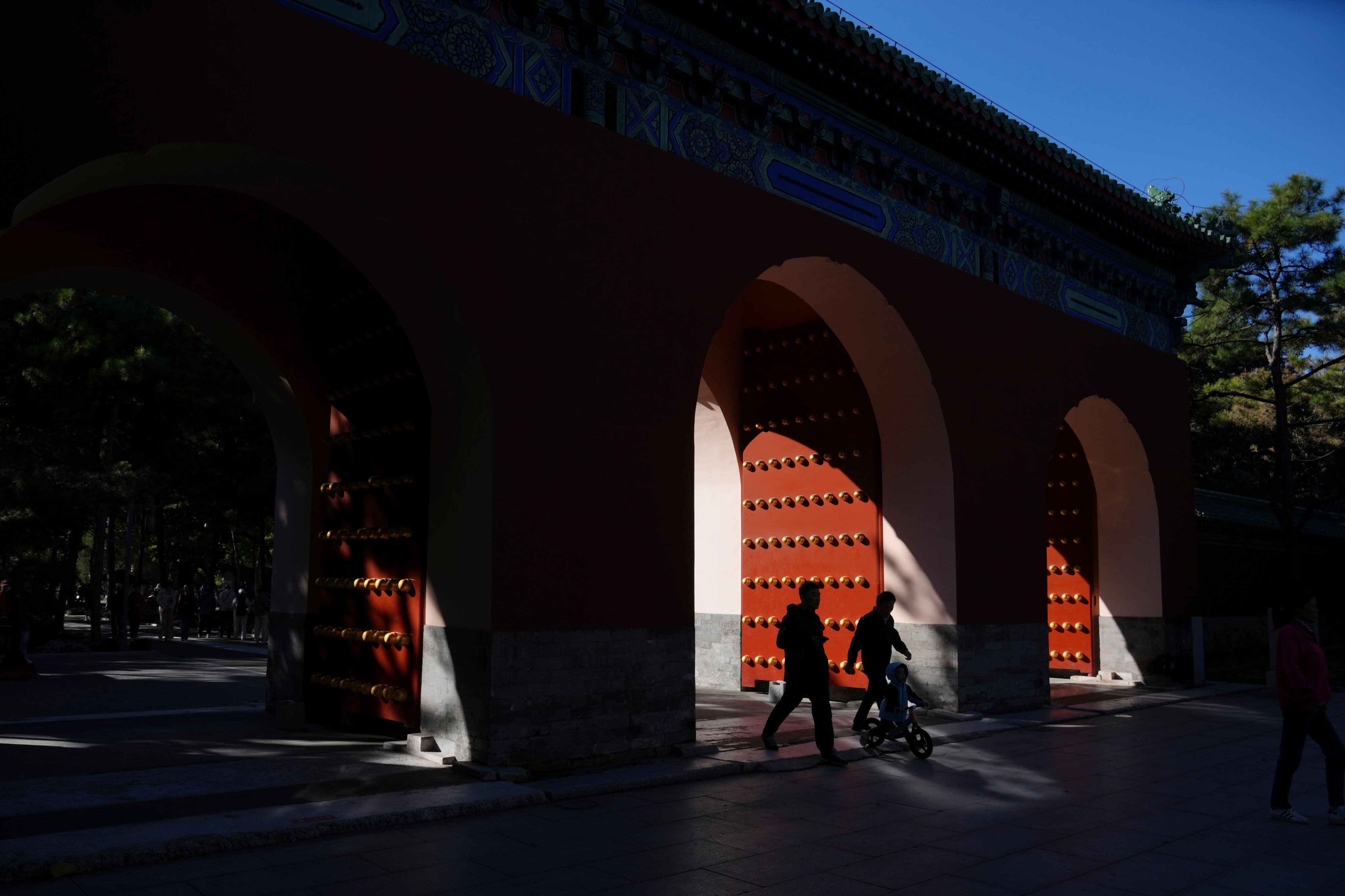 People walk through a garden in Beijing on October 18. Photo: AP