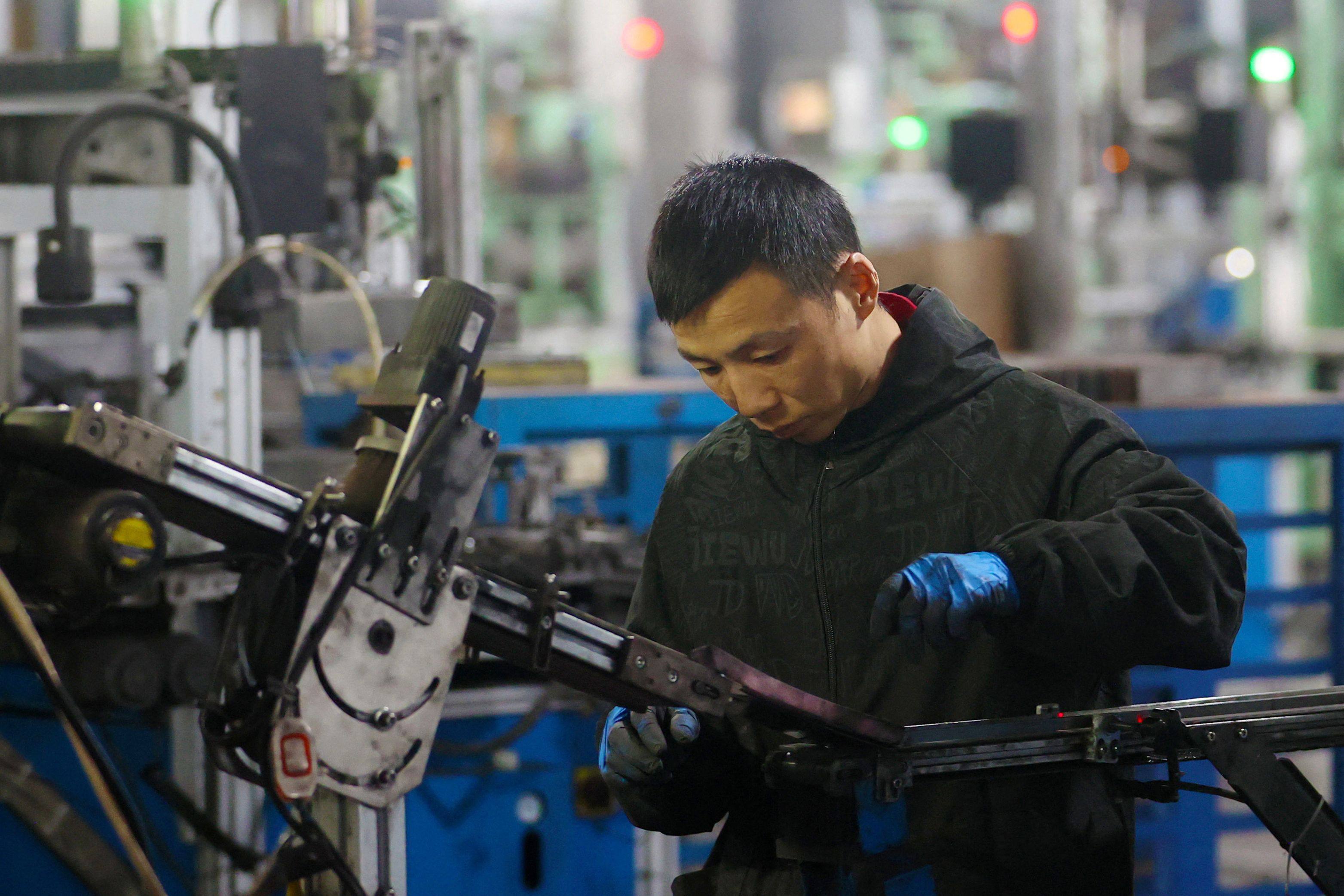 A worker produces magnetic components in the workshop of Yaorun Technology in the high-tech zone of Qianjiang District in Chongqing, southwest China on October 26. Photo: CN-STR/AFP