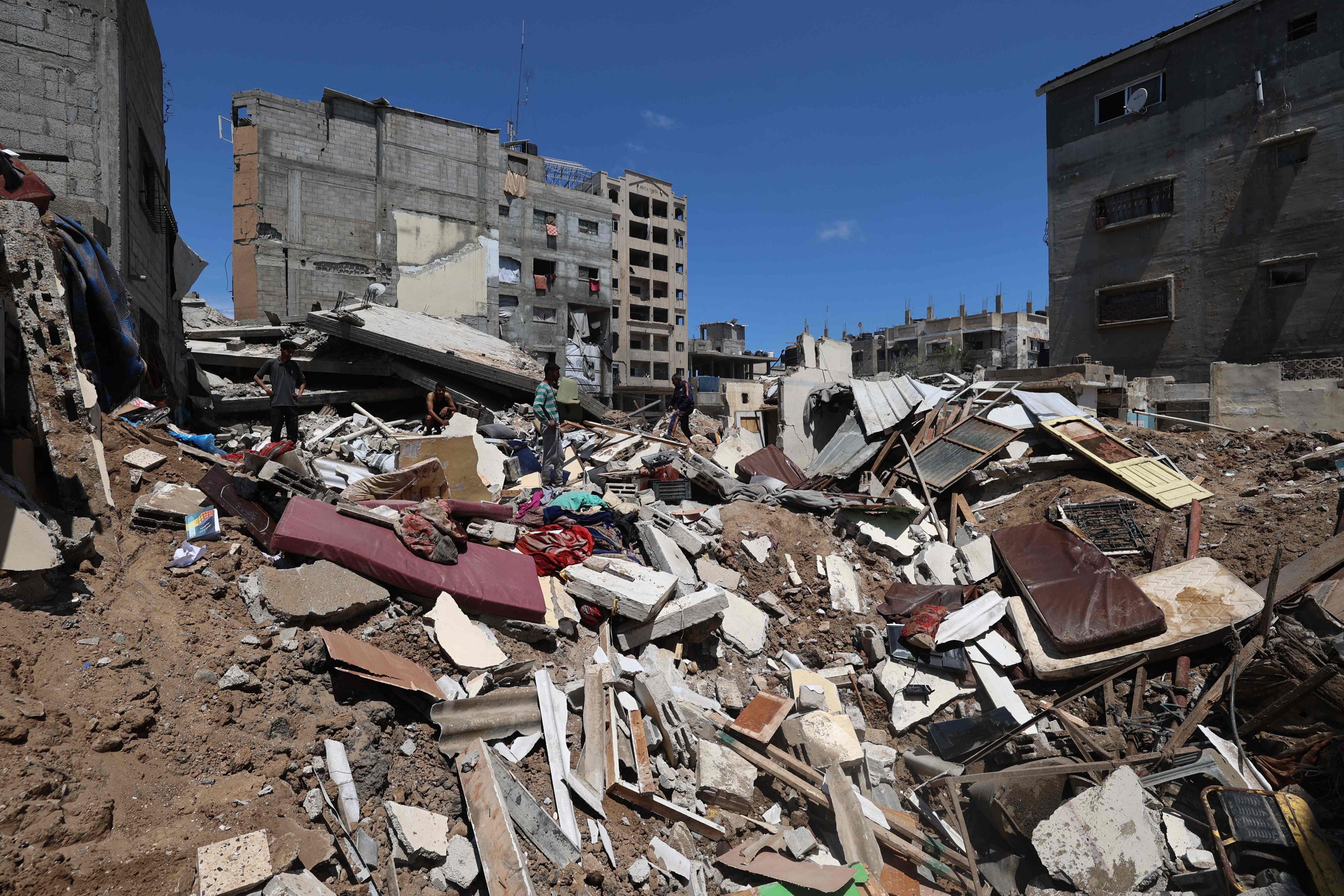Palestinians inspect the damage following overnight Israeli strikes at the Nuseirat refugee camp in Gaza Strip in May last year. Photo: AFP