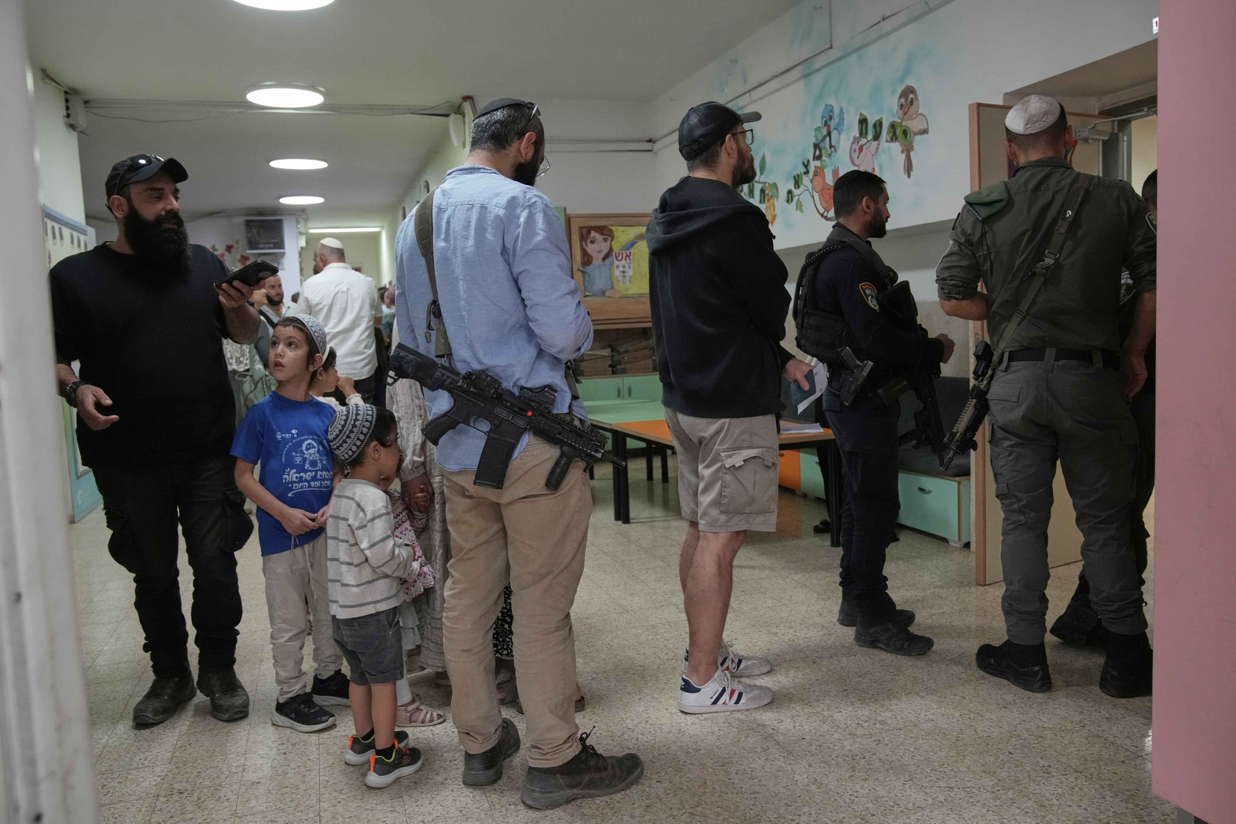 Israeli settlers line up to vote in the settlement of Kiryat Arba, in the occupied West Bank. Photo: AP